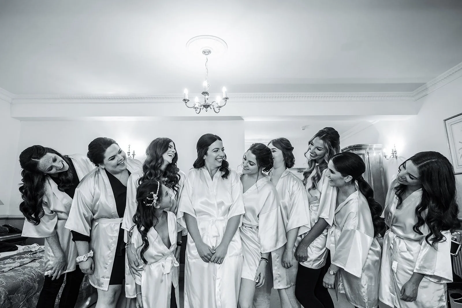 Bridal party laughing in robes during morning preparations at Nunsmere Hall