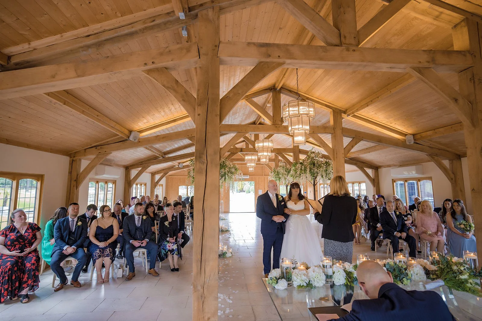 wide angle view of bride and groom exchanging vows at colshaw hall in cheshire