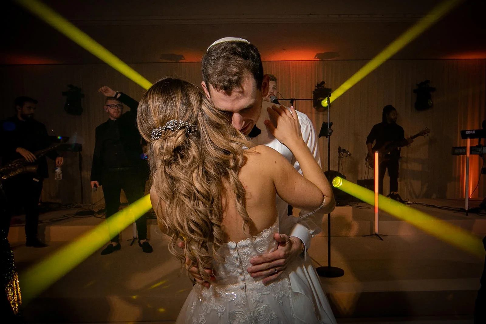 First dance - bride and groom close together under dramatic lighting, The Mere

