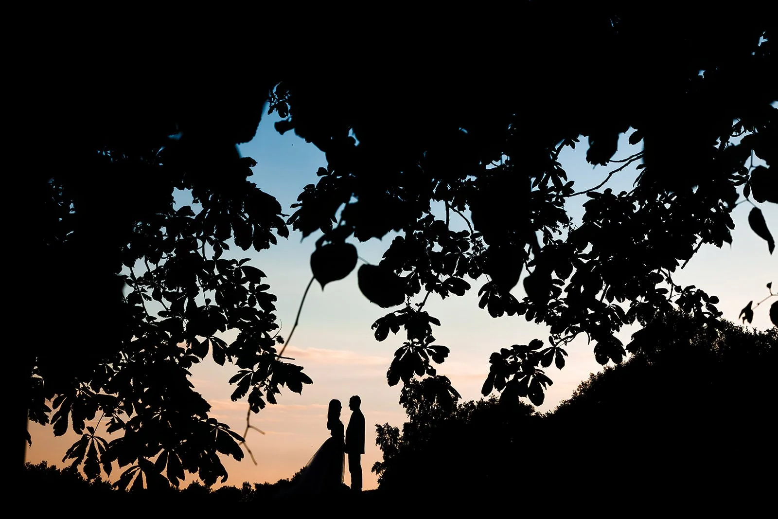 silhouette newlywed bride and groom portrait outdoors at worsley marriott hotel wedding venue