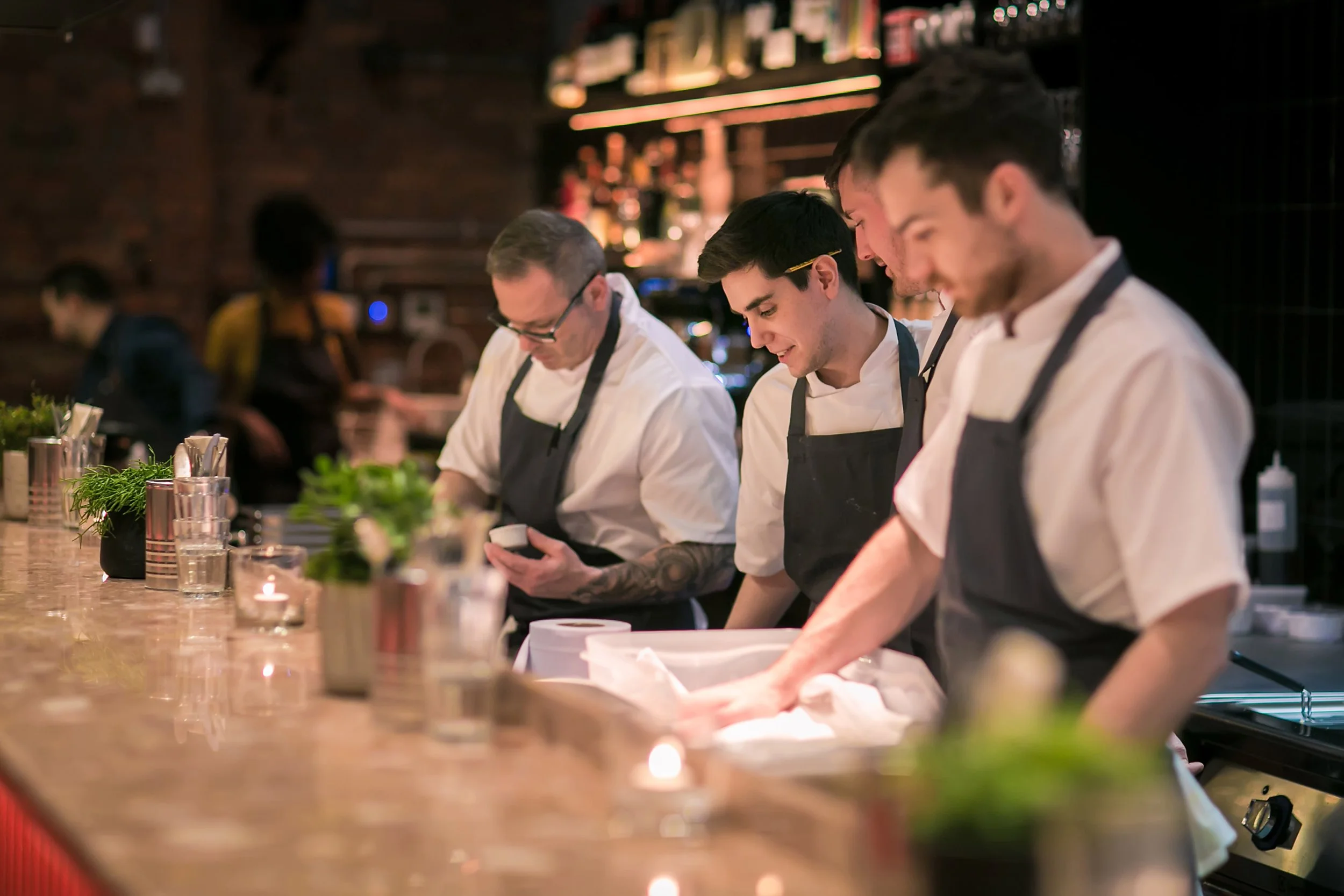 Hospitality staff preparing food during a corporate event