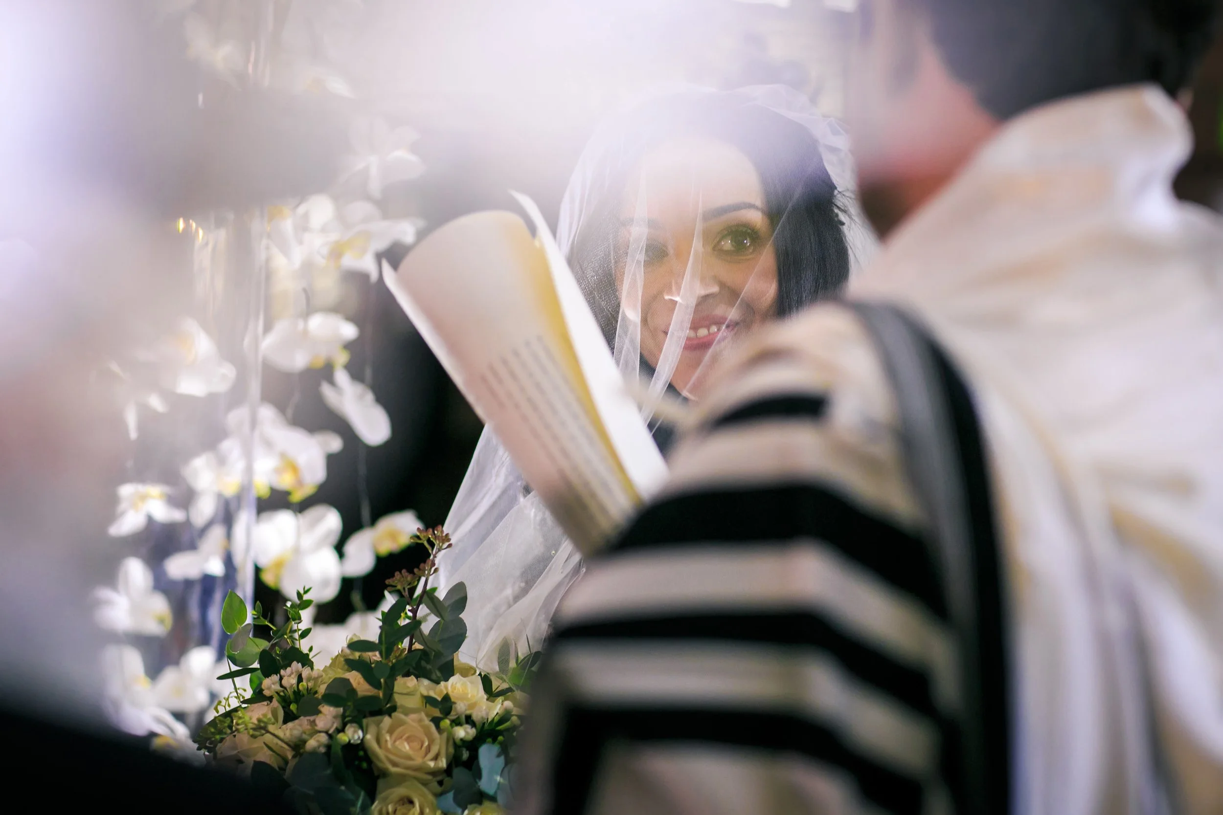 bride and groom with ketubah under the chuppah during Jewish ceremony and photographed by a Manchester wedding photographer 