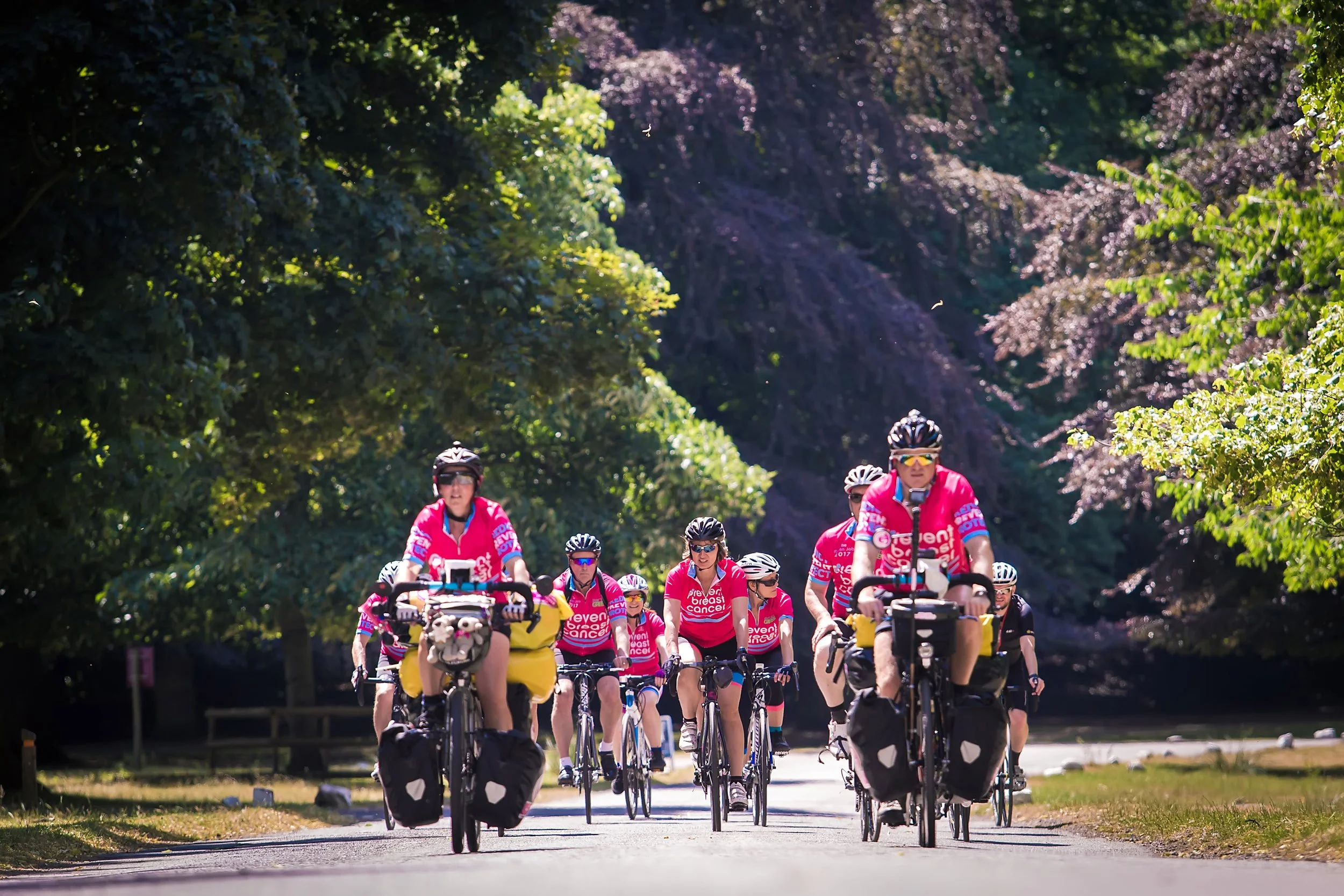 Charity cycle event participants riding through a community fundraising event