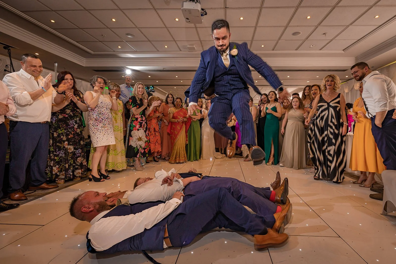 groom jumps over guests during reception party at worsley marriott hotel