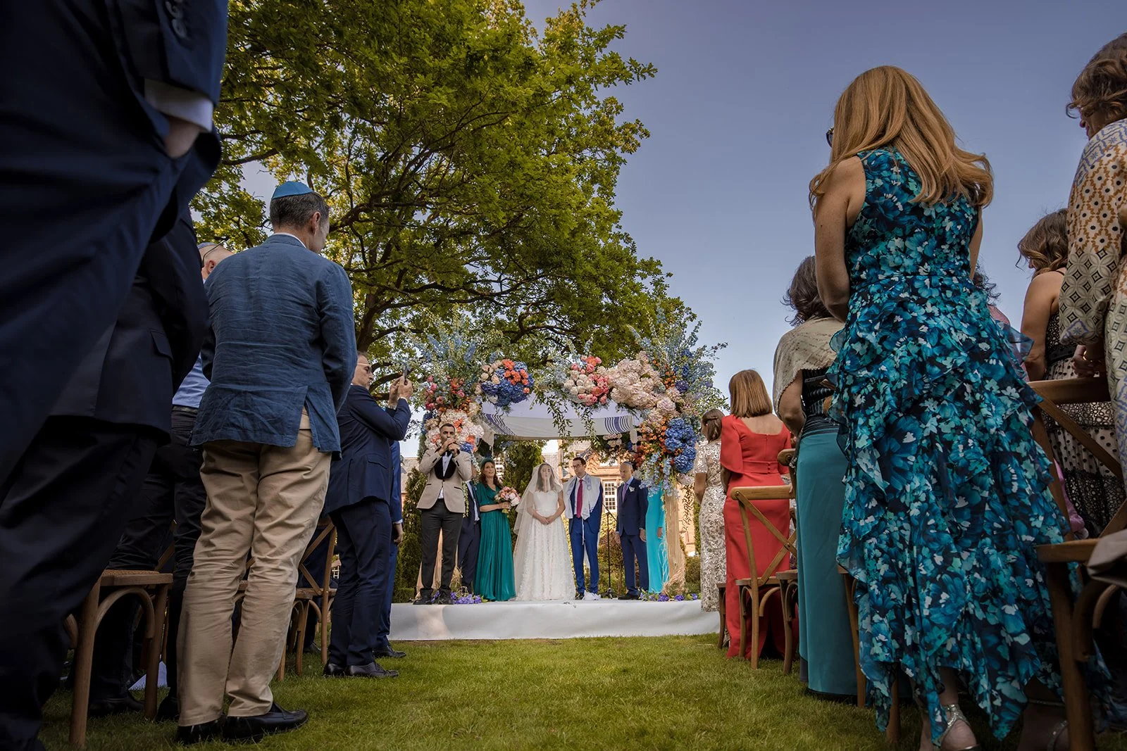 Jewish wedding ceremony under colourful floral chuppah at Nunsmere Hall Cheshire
