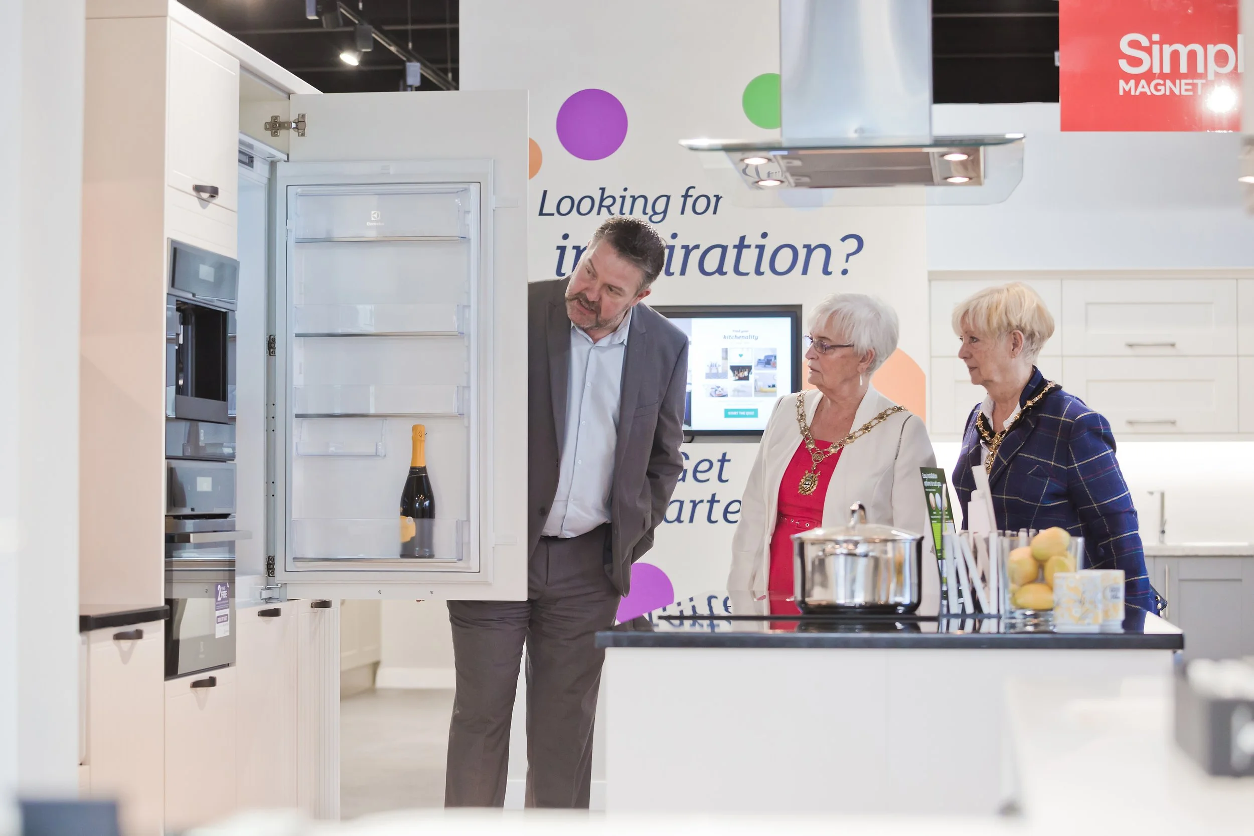 VIP guests touring a kitchen showroom during a corporate event