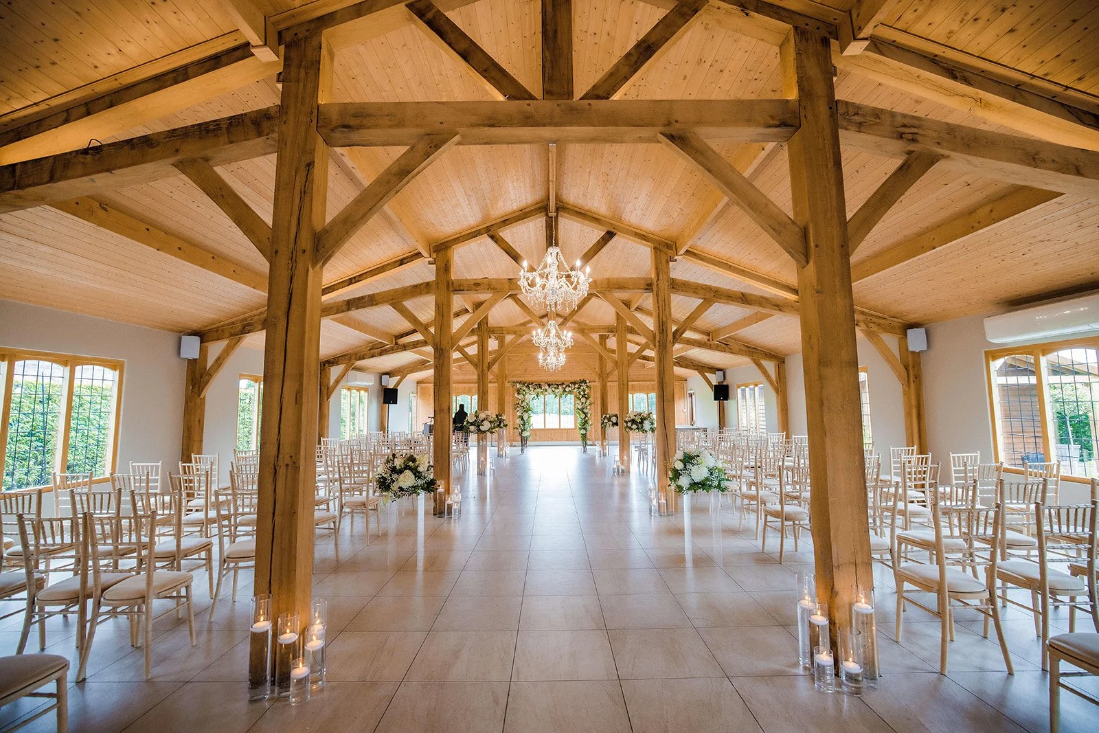 Merrydale Manor wedding ceremony barn with chandeliers white chairs – wedding photographer North West England
