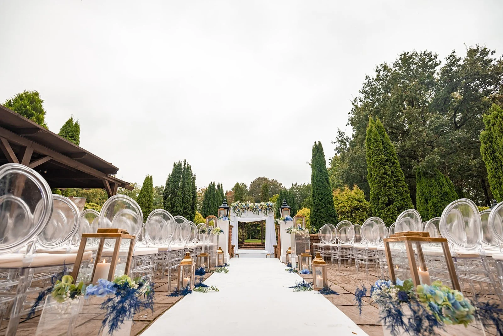 Outdoor ceremony setup with chairs and arch, Nunsmere Hall Italian gardens
