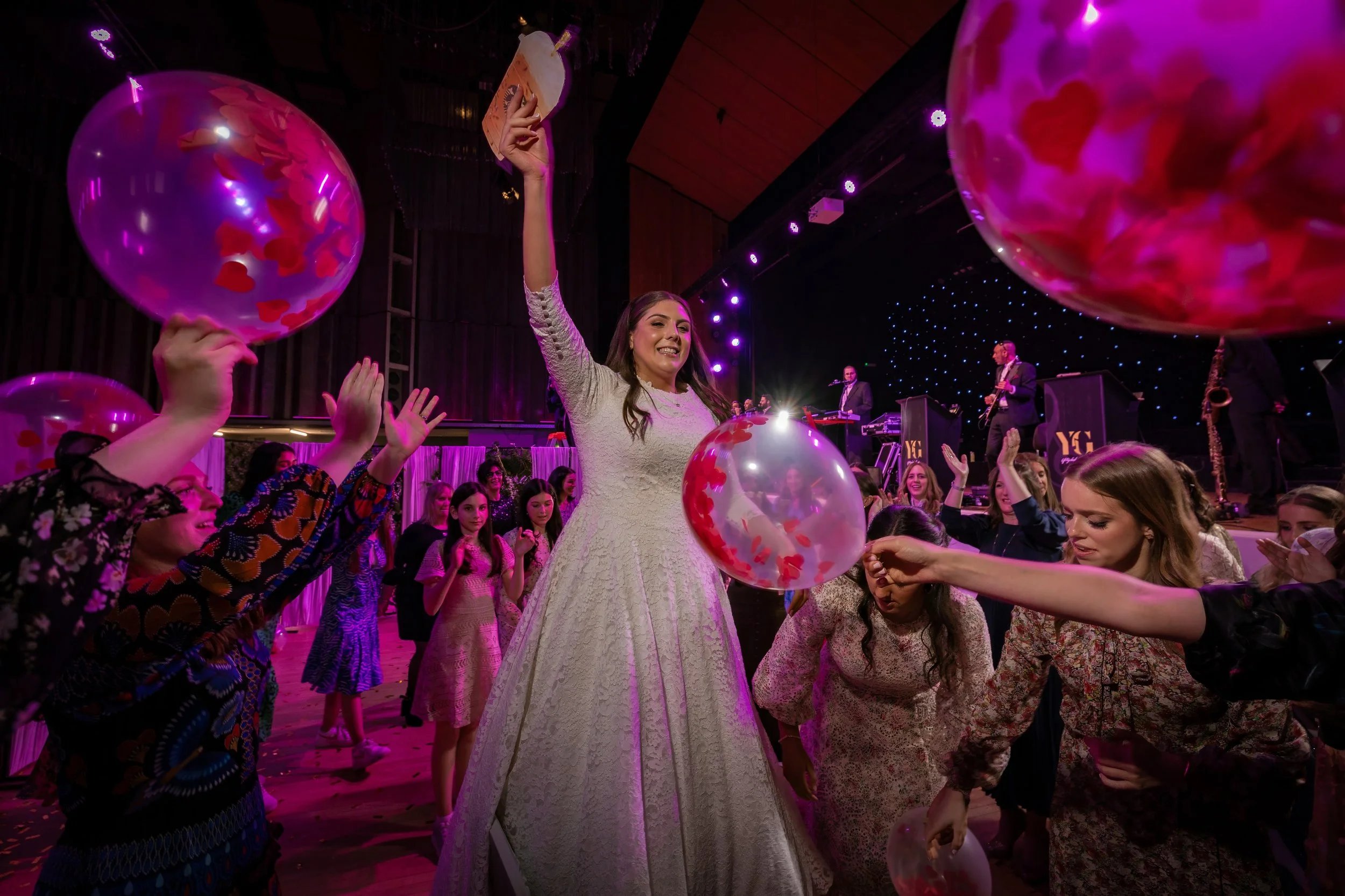 kallah bride surrounded by friends on dancefloor at charedi jewish wedding