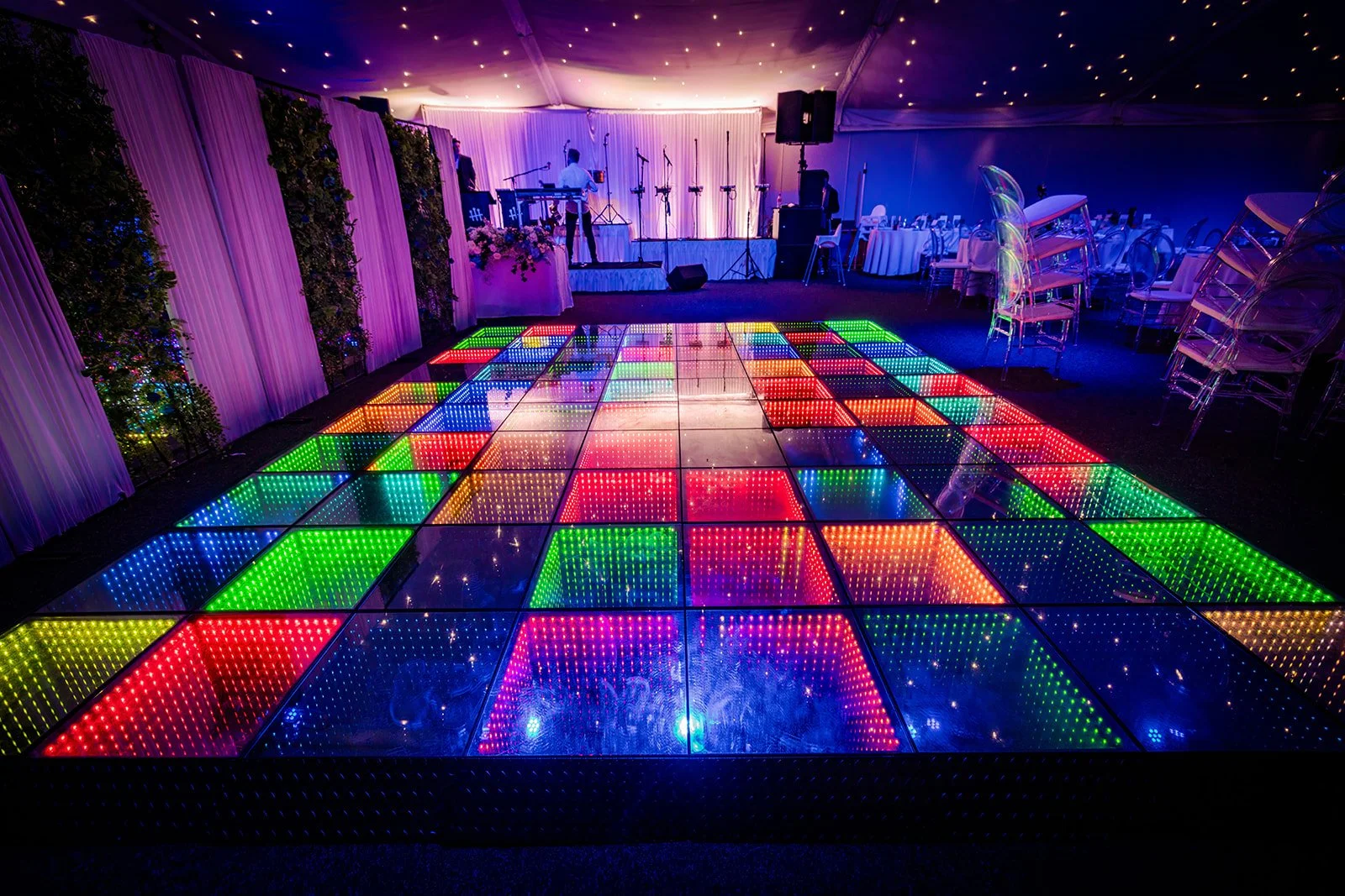 Illuminated LED multicoloured dance floor in Nunsmere Hall wedding marquee
