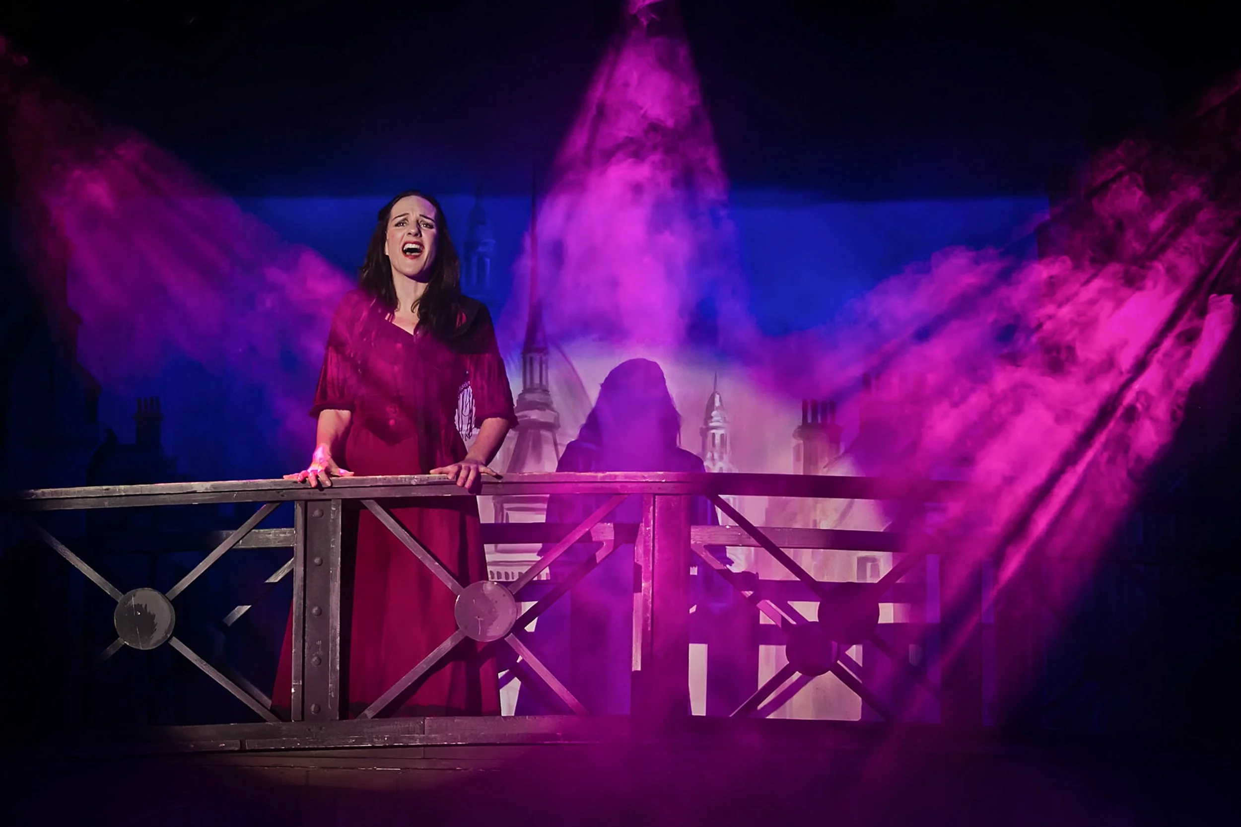 nancy singing during oliver musical stage production photography with lighting and smoke