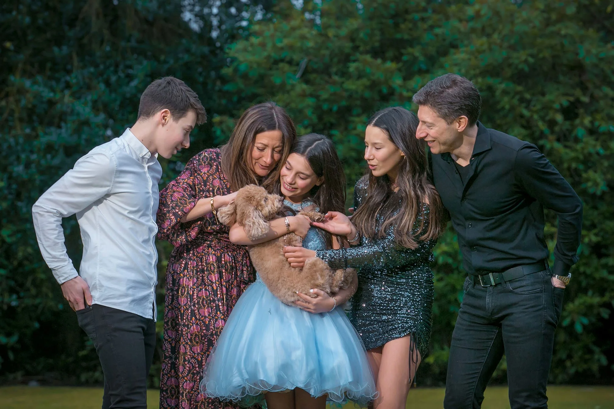 family portrait in garden with pet dog