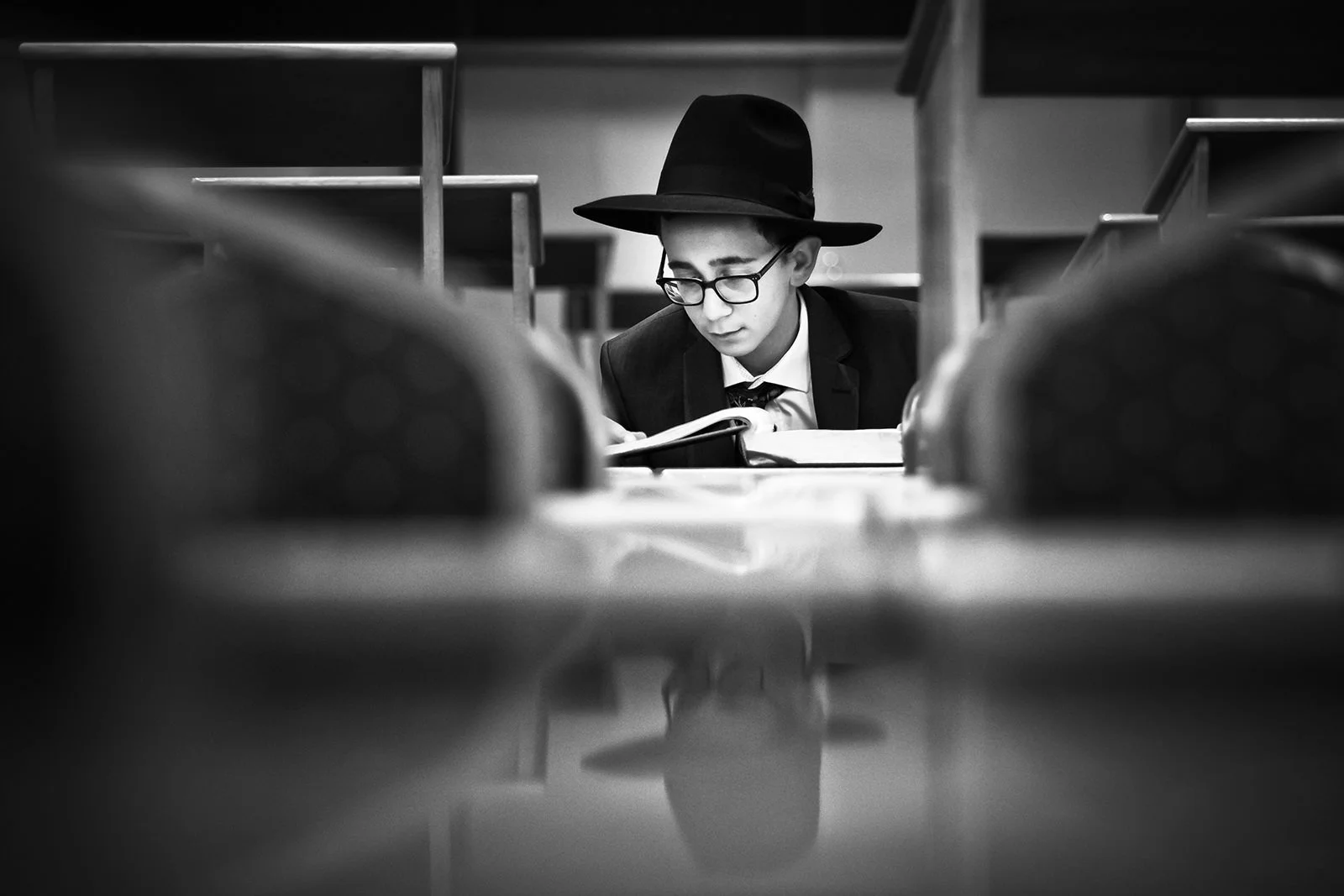 barmitzvah boy practicing his piece during rehearsal in synagogue