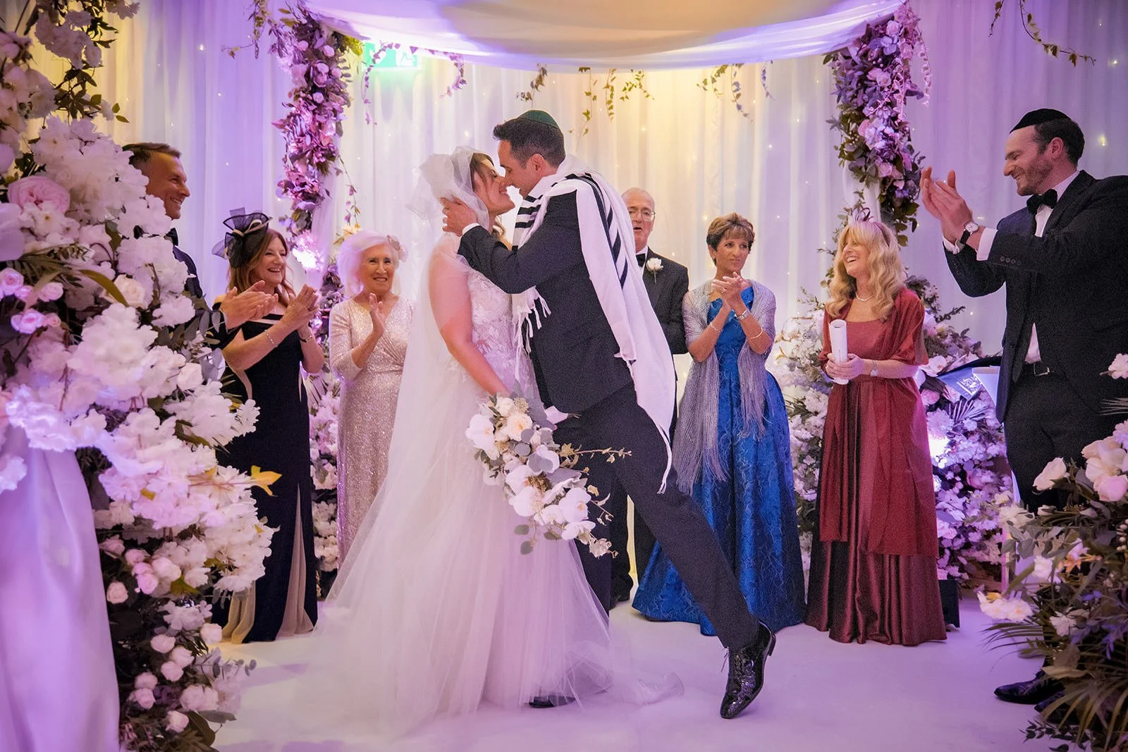 Bride and groom walking back up the aisle with guests celebrating, The Mere Knutsford
