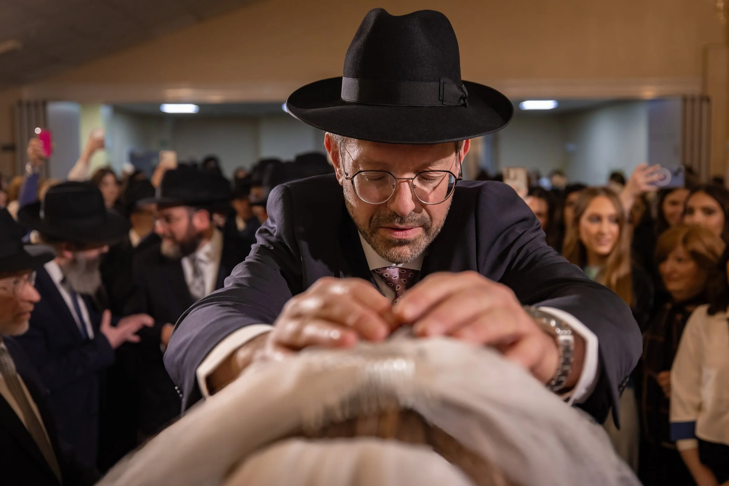 father-of-the-bride gives blessing to the bride during bedeken