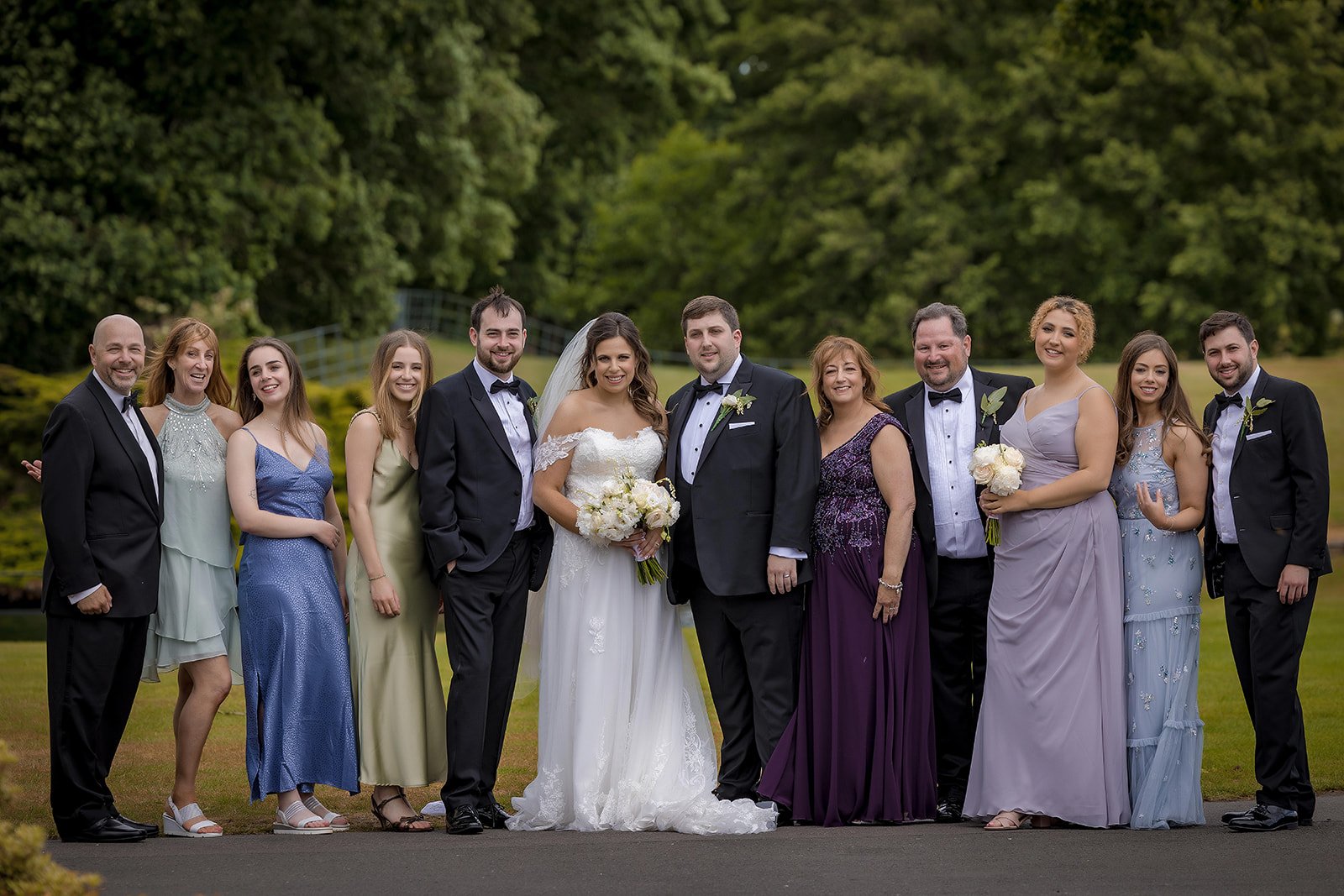 Merrydale Manor wedding party group portrait on lawn outdoors – wedding photography Cheshire