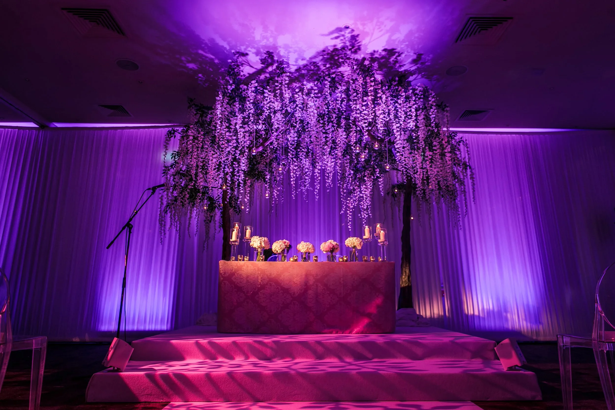 Jewish wedding ceremony room with elaborate purple floral chuppah, The Mere Knutsford
