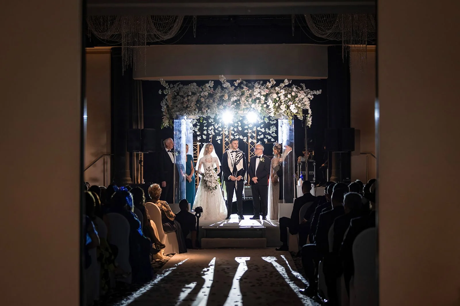bride and groom exchange vows under chuppah at mercure manchester piccadilly wedding ceremony