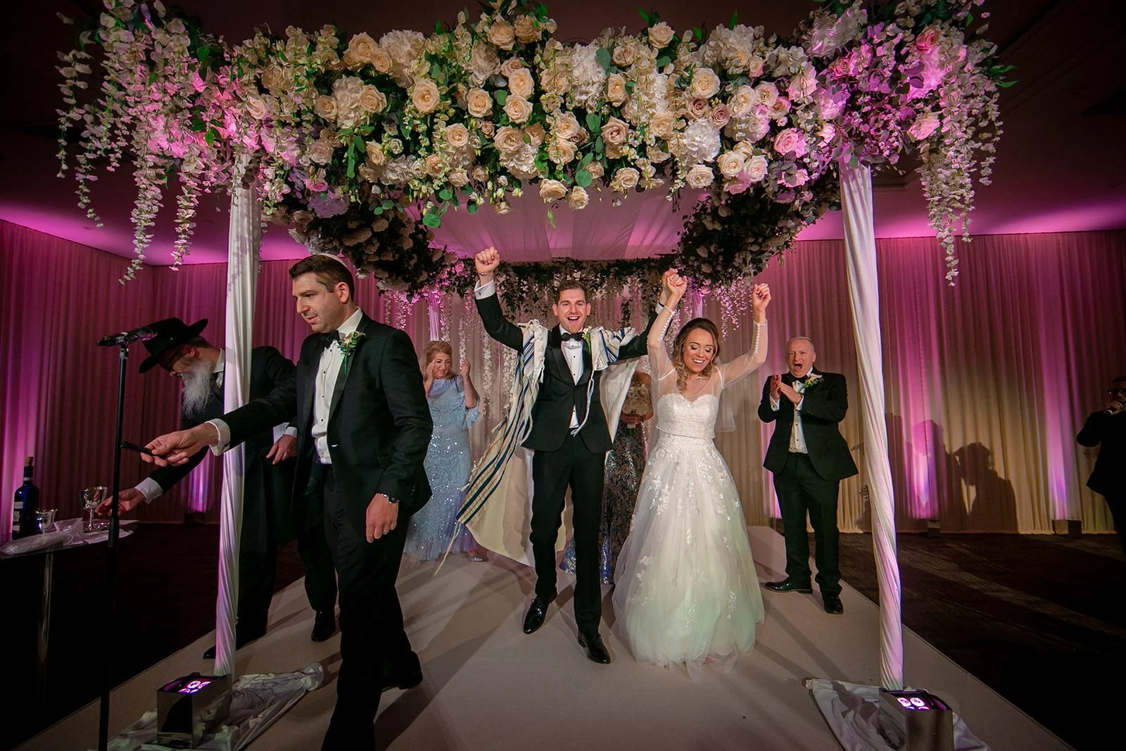 bride and groom leave wedding ceremony at mere golf resort in cheshire