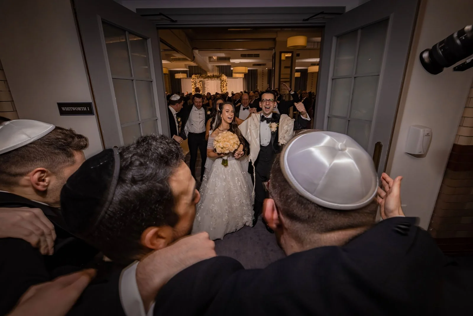 bride and groom leave wedding ceremony in ballroom at kimpton clocktower manchester