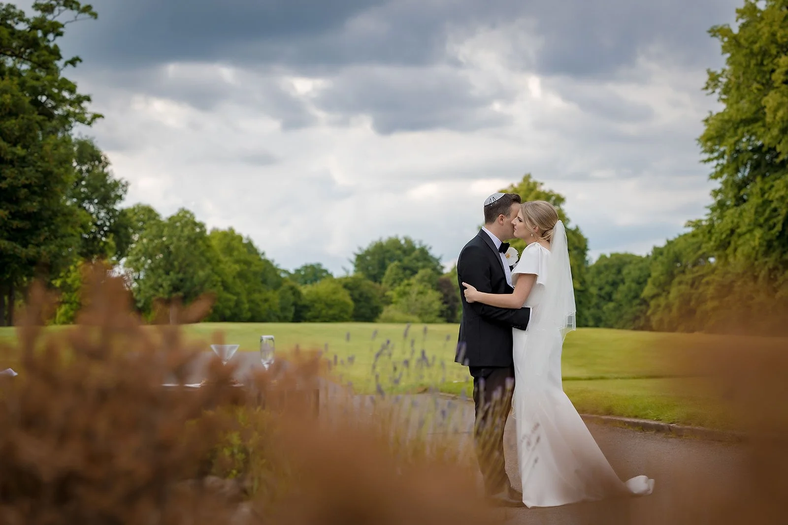Couple embracing on the golf course at The Mere, Fairmont Cheshire
