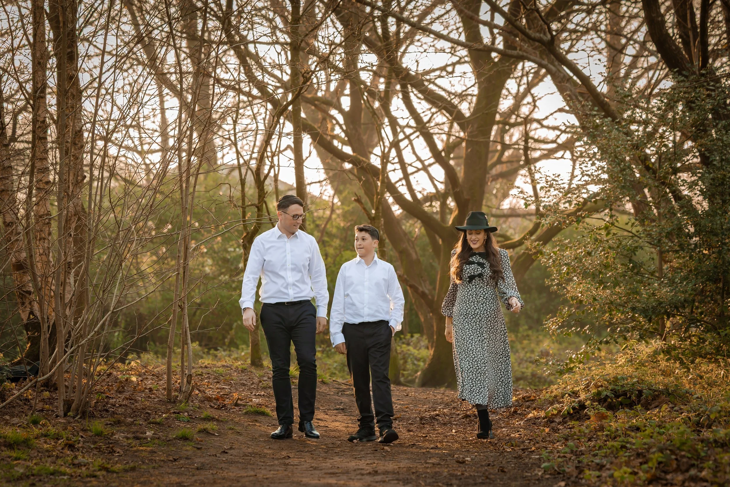 barmitzvah boy and parents walking outdoors portrait