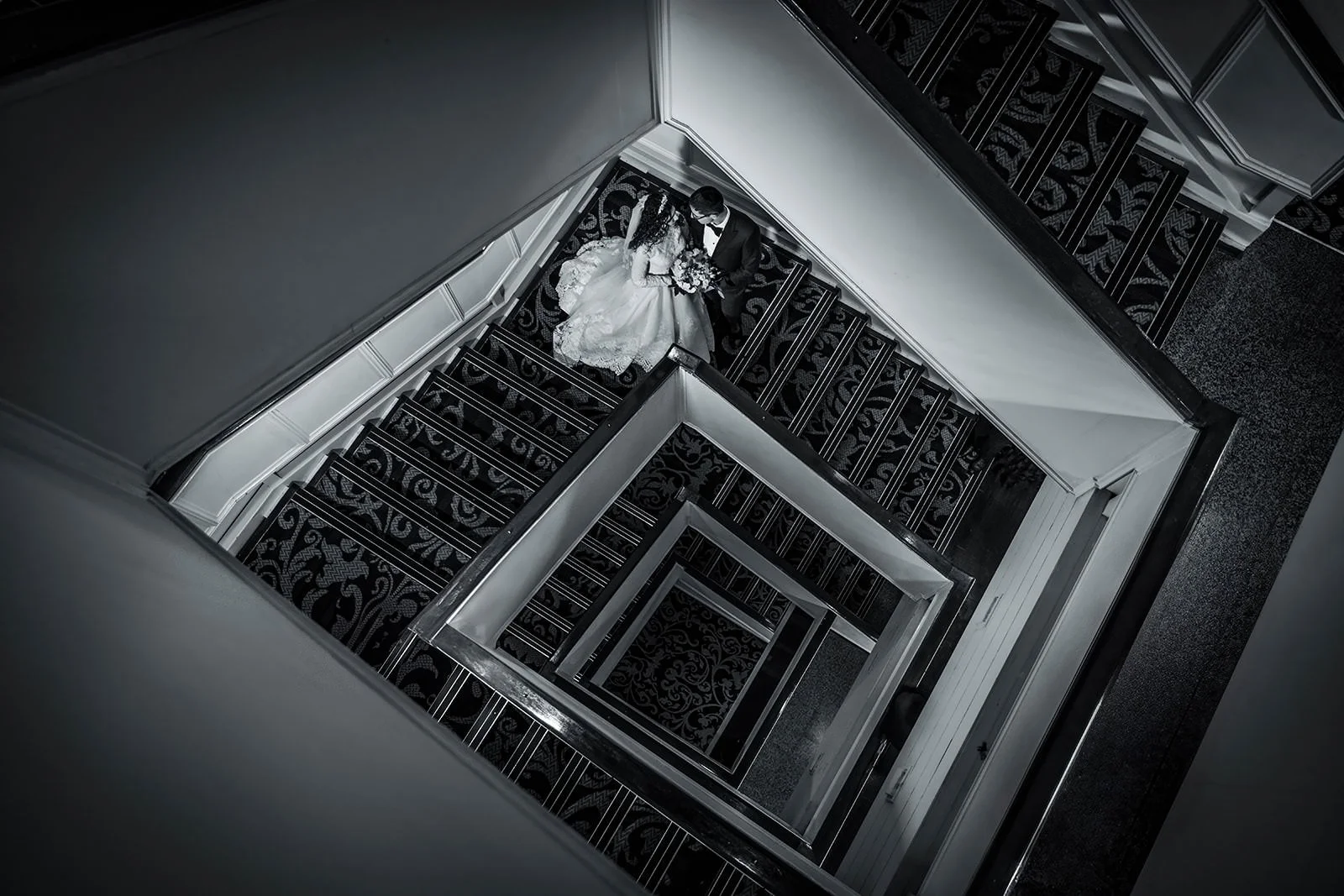 geometric newlywed couple portrait on stairs at mercure manchester piccadilly