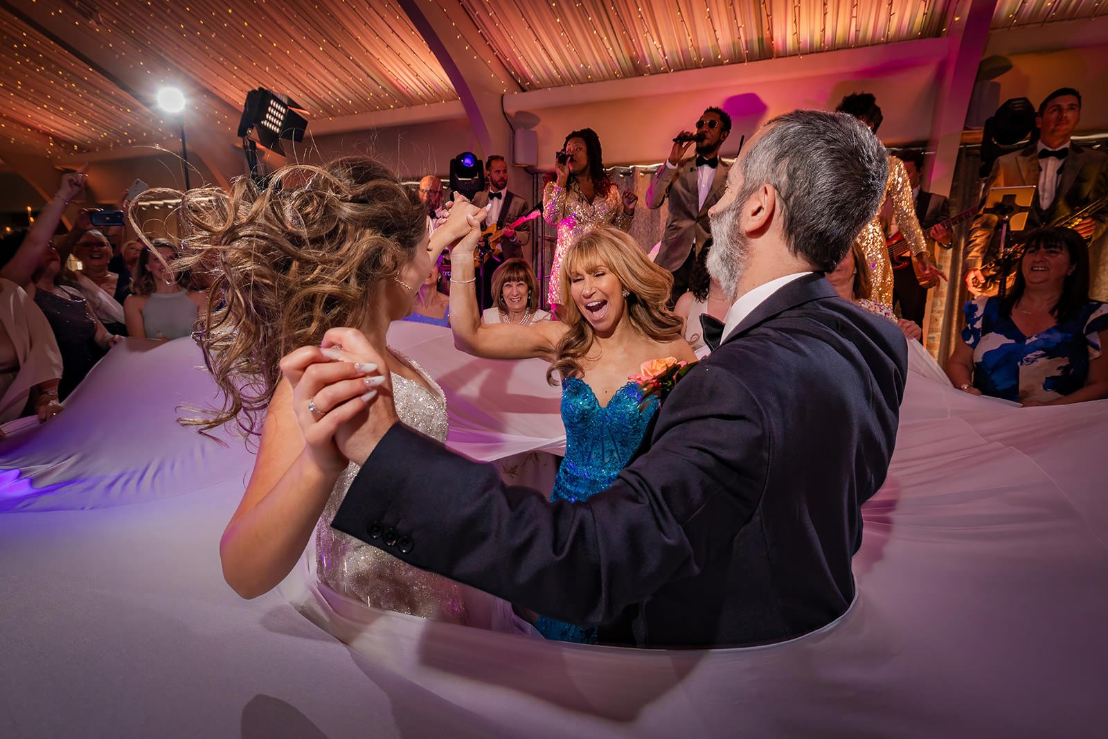 bride and parents partying on dance floor at colshaw hall wedding venue