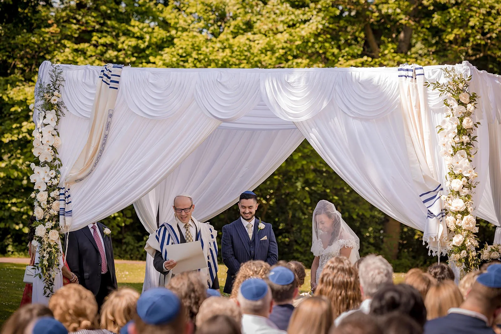 bride and groom exchange vows duuring outdoor wedding ceremony at worsley marriott hotel