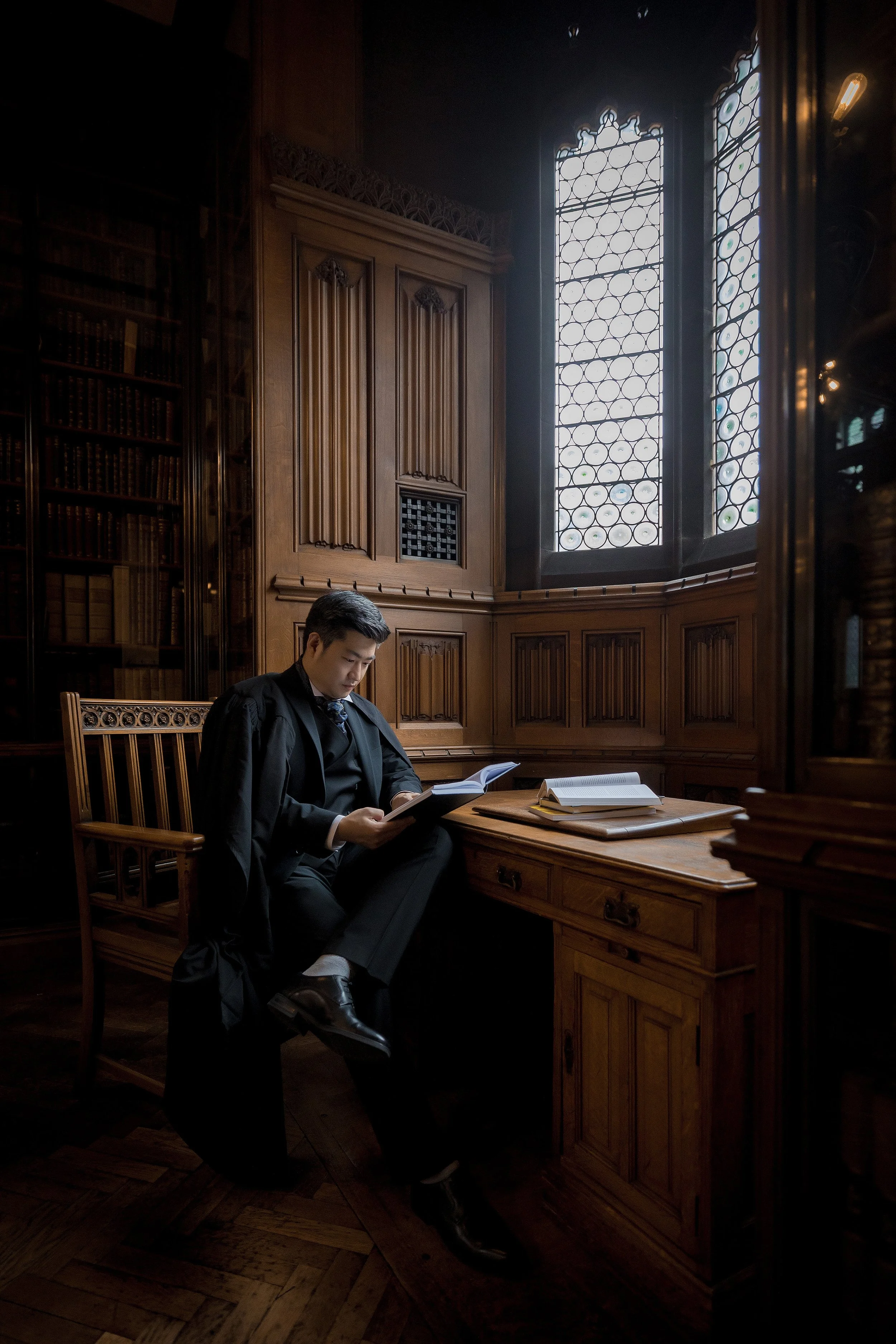 graduation portrait in manchester university john rylands library with gown