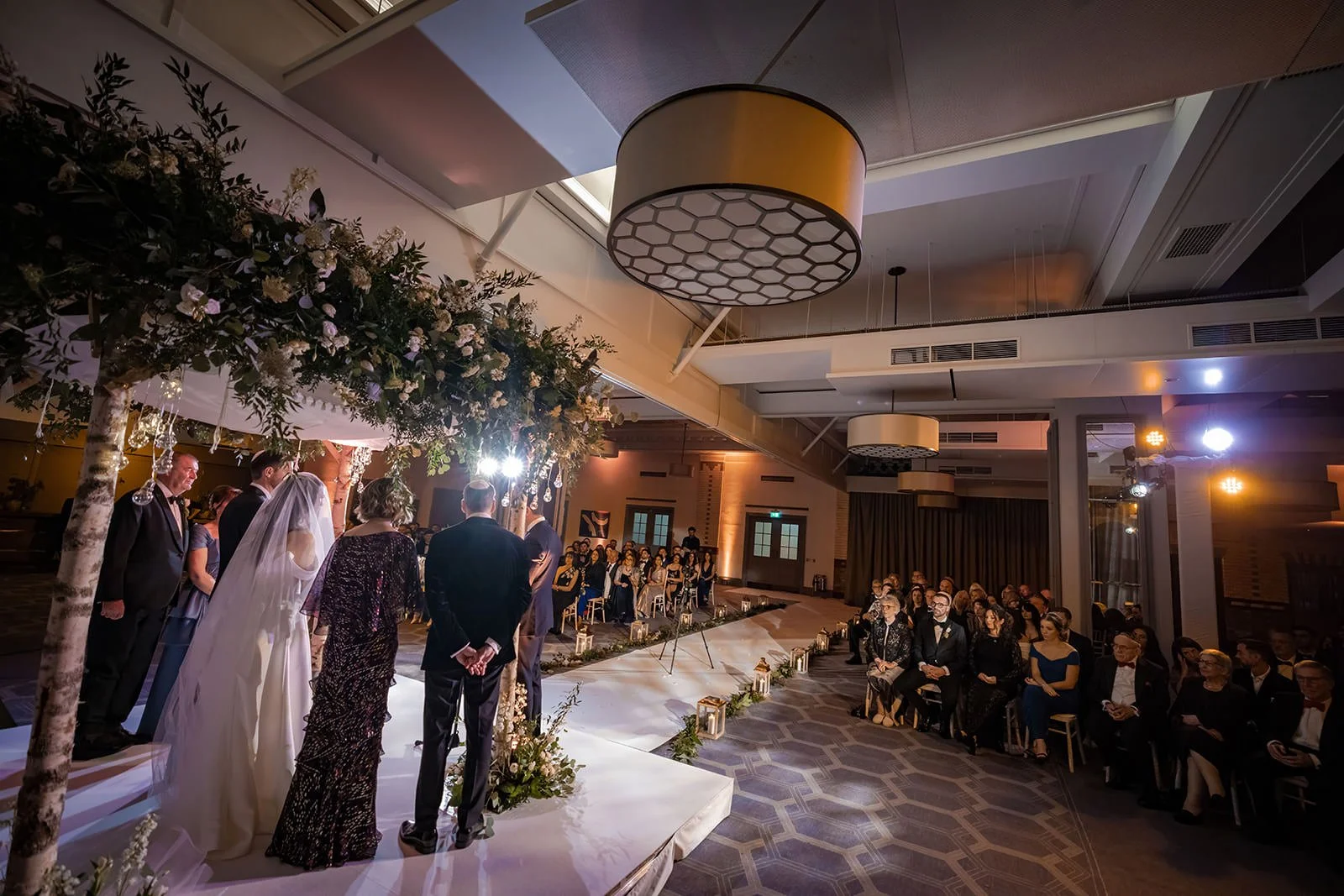 bride and groom exchange vows during wedding ceremony in ballroom at kimpton clocktower manchester