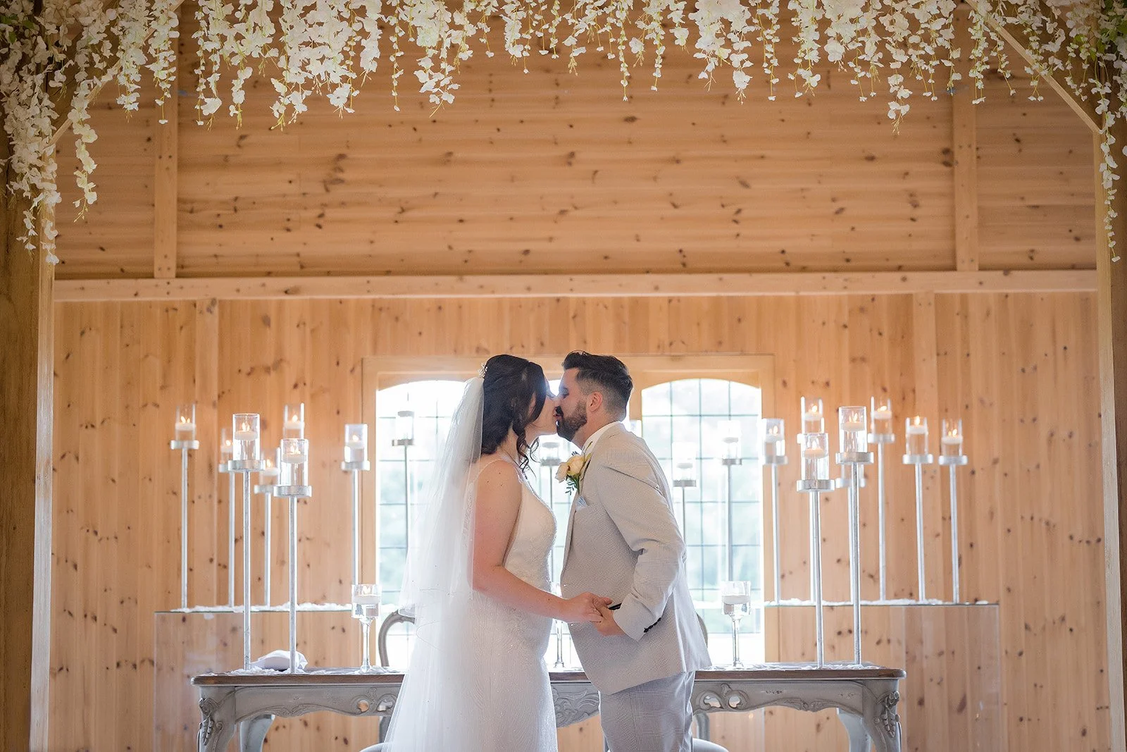 Merrydale Manor wedding couple first kiss inside wooden chapel – Manchester wedding photographer