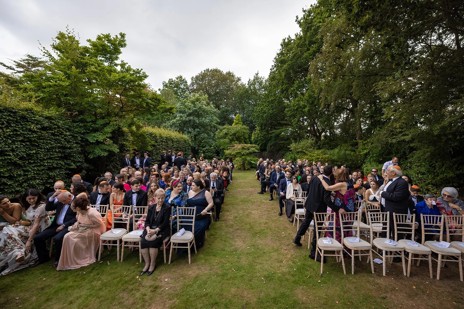 Bride and groom exchanging vows at outdoor garden ceremony, Nunsmere Hall


