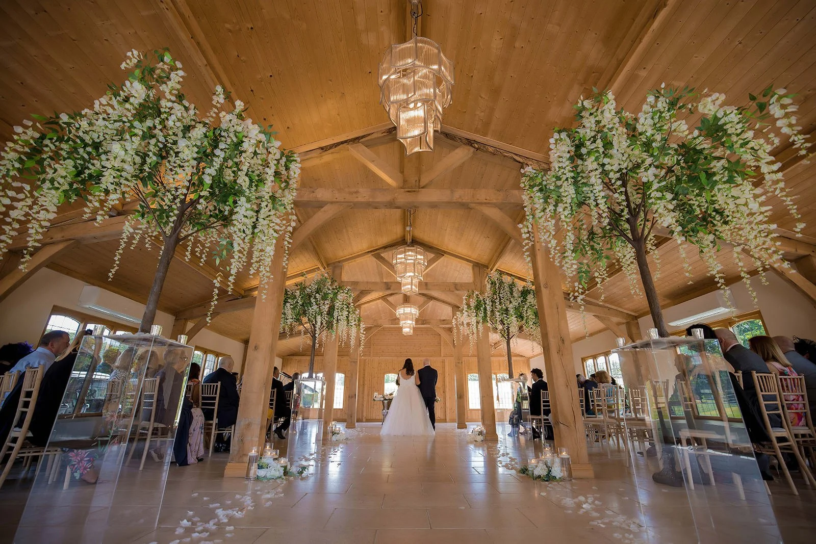 wide angle view from back of ceremony room of bride and groom exchanging vows at colshaw hall in cheshire
