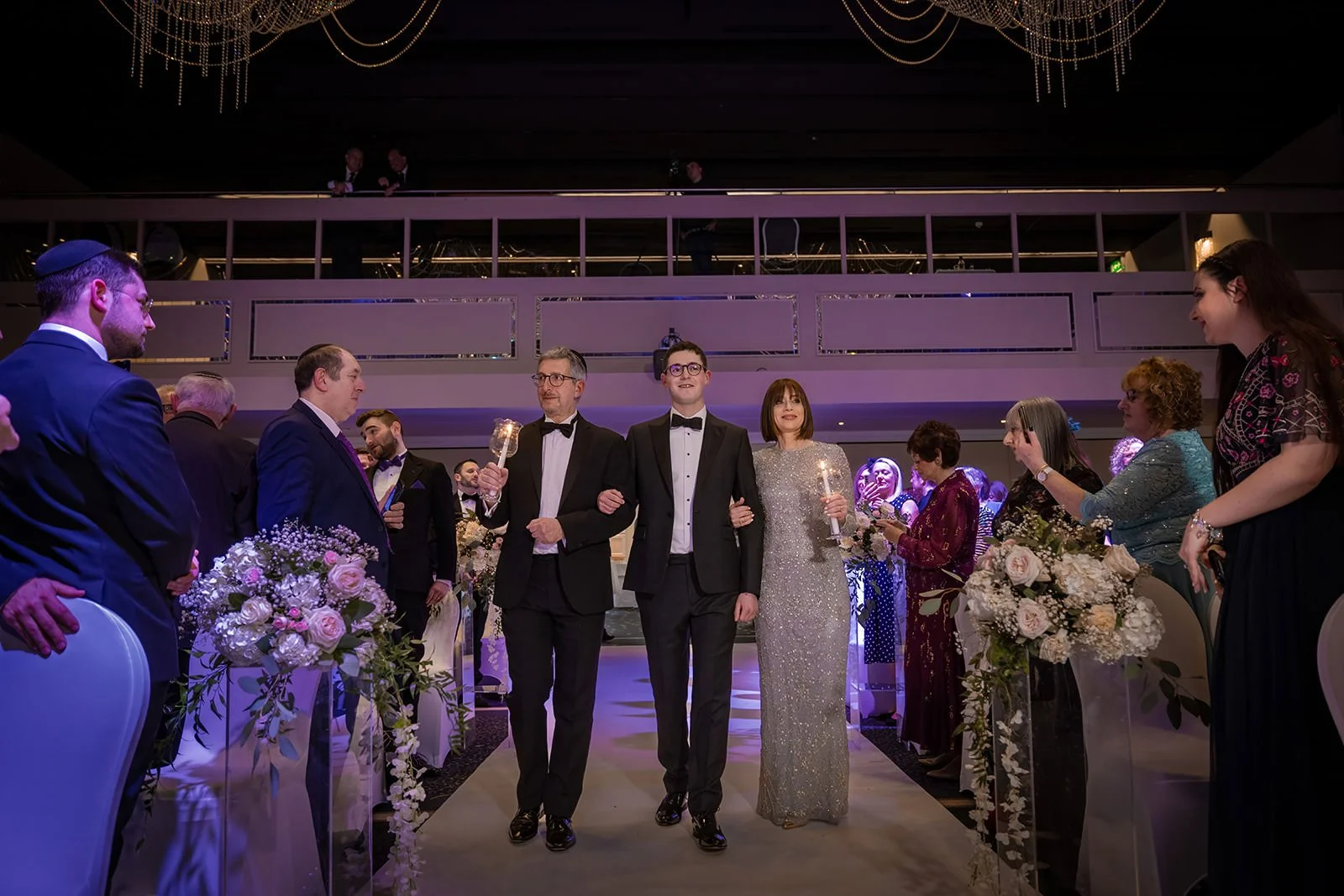 groom and parents walk down aisle during wedding ceremony in international suite at mercure manchester piccadilly