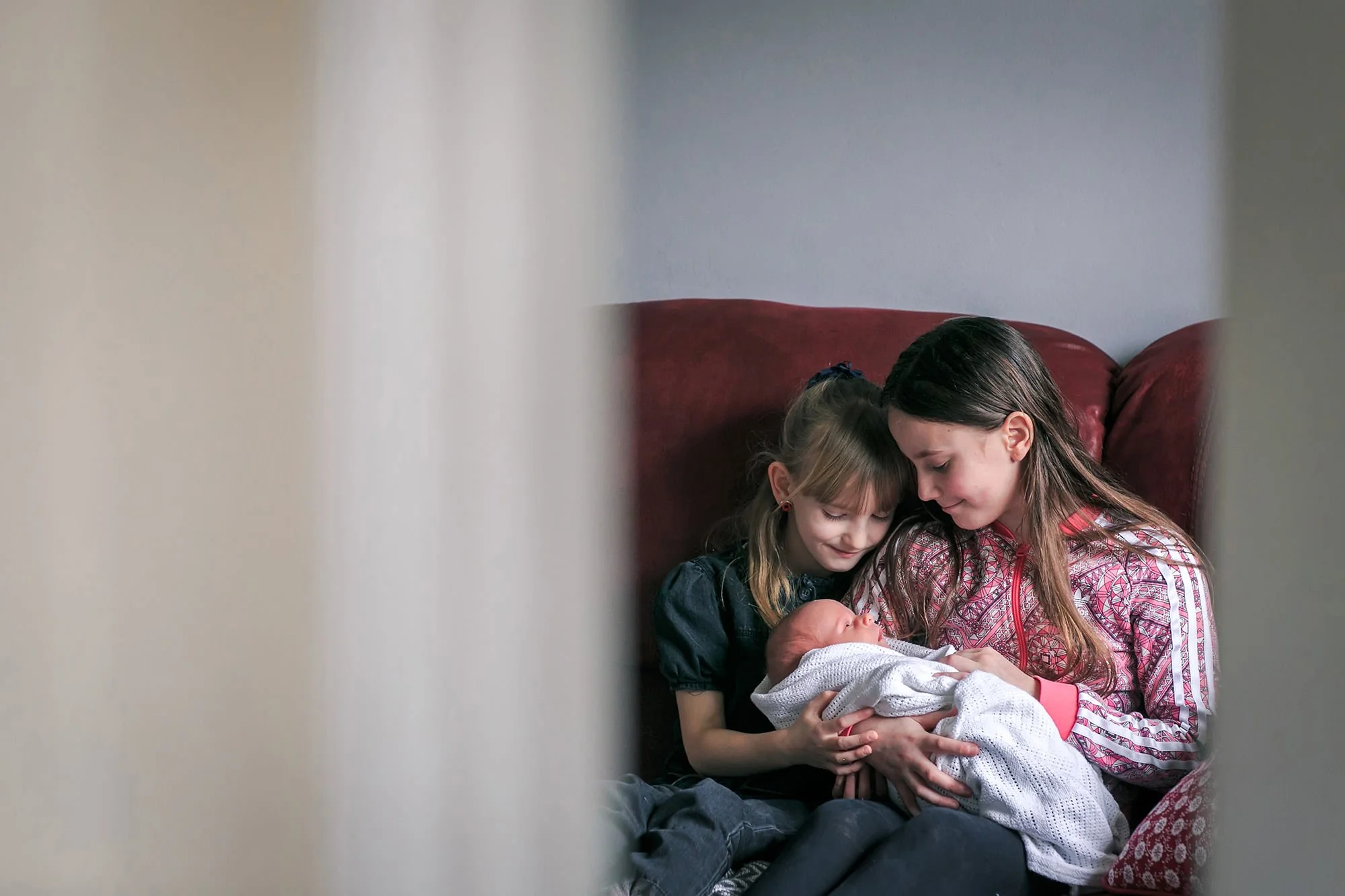 newborn baby portrait with sisters