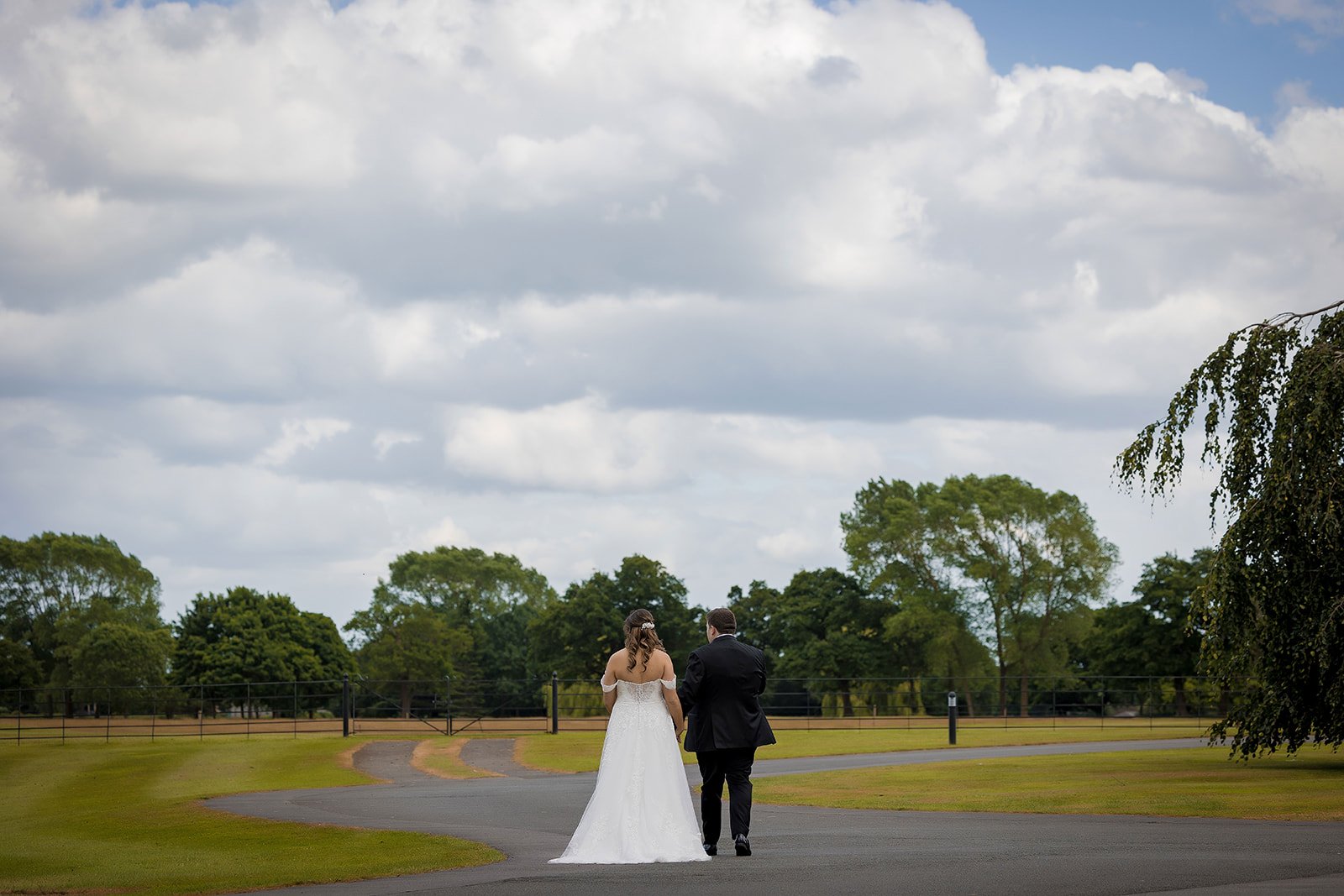 bride and groom walking away portrait at merrydale manor in cheshire