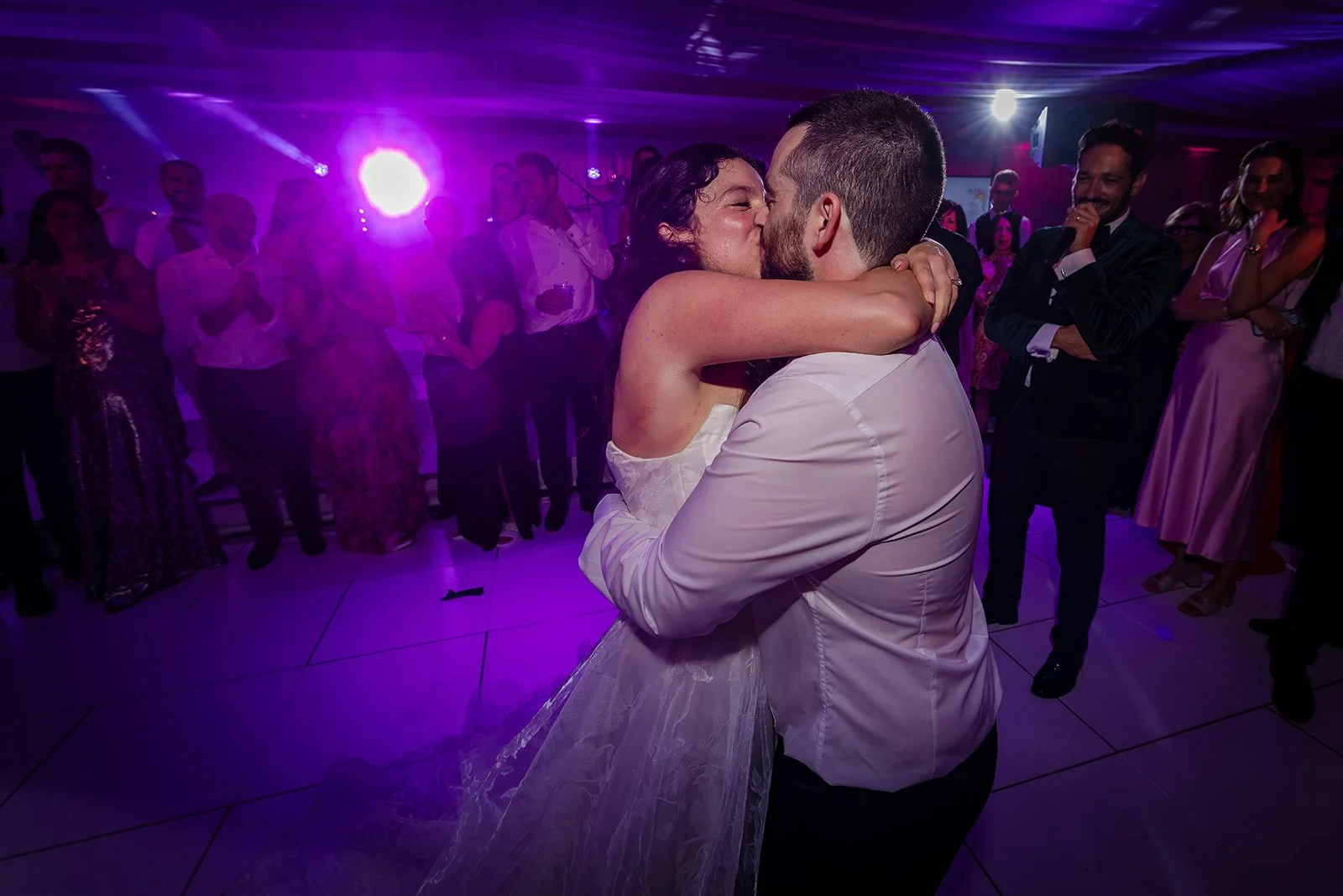 Bride and groom on dance floor in Nunsmere Hall marquee, evening wedding reception
