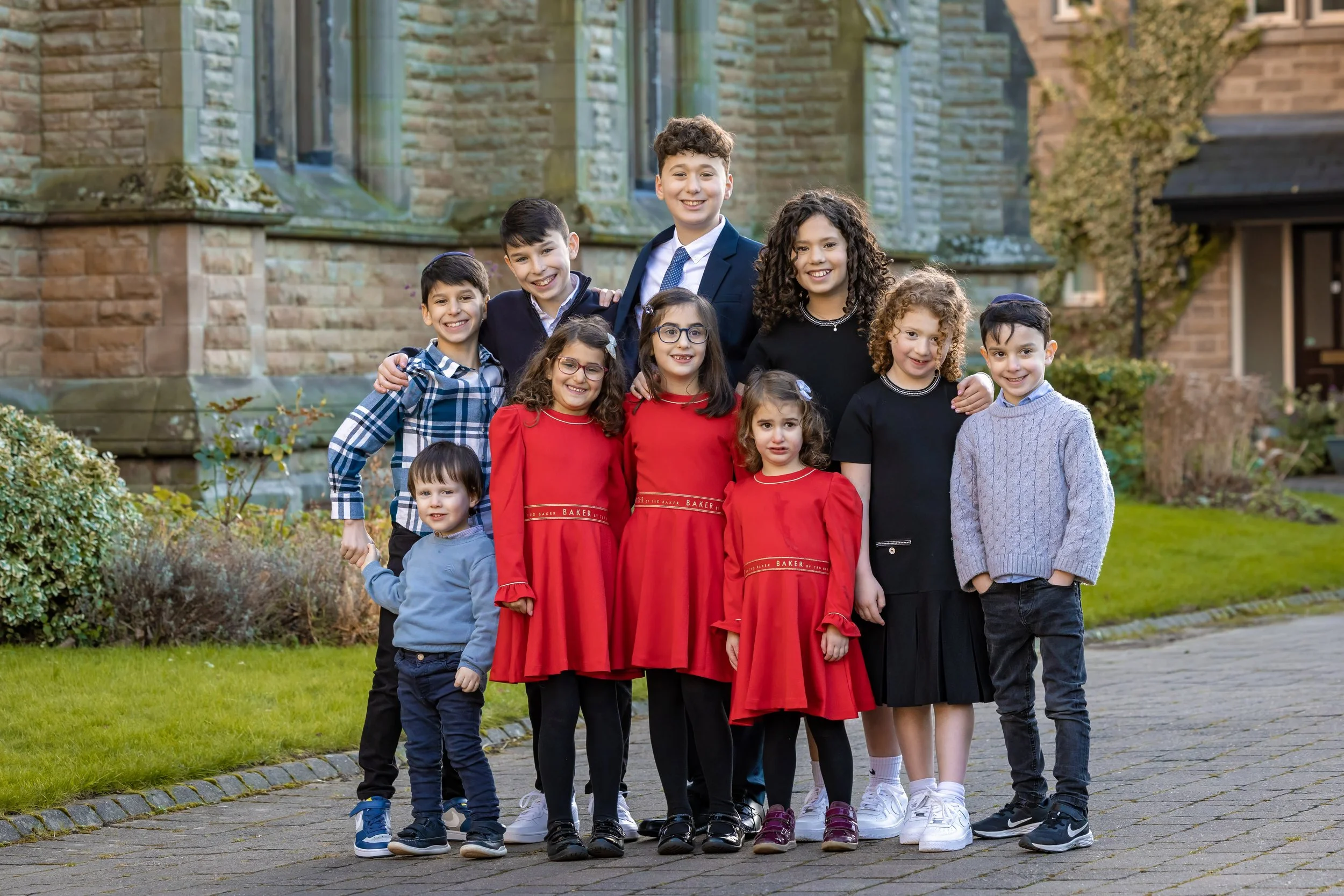 barmitzvah boy and brothers and sisters and cousins portrait in Manchester