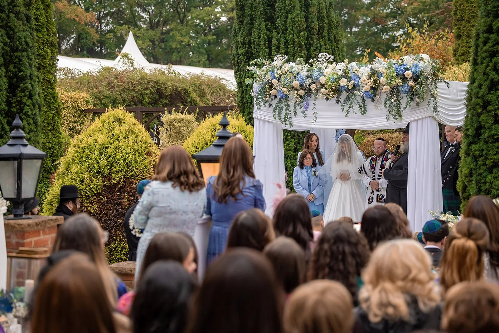 bride and groom exchange vows during outdoor wedding ceremony at nunsmere hall in cheshire