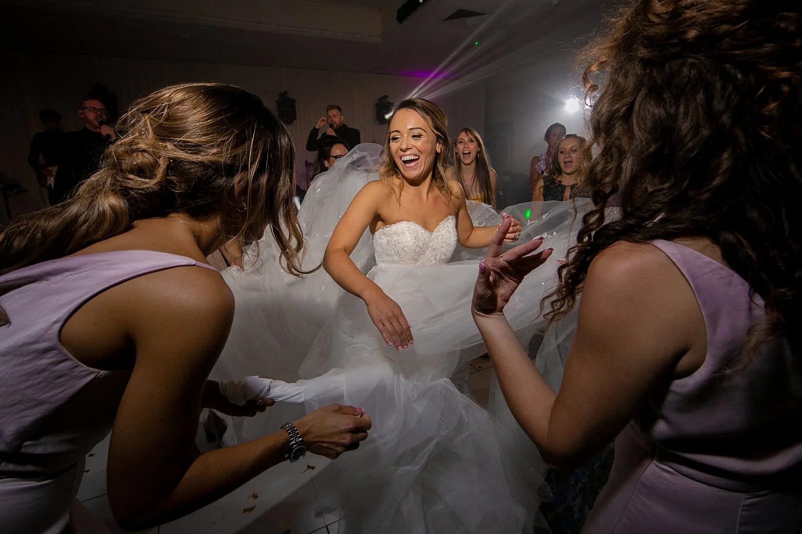 Bride dancing with guests at evening reception, The Mere Knutsford
