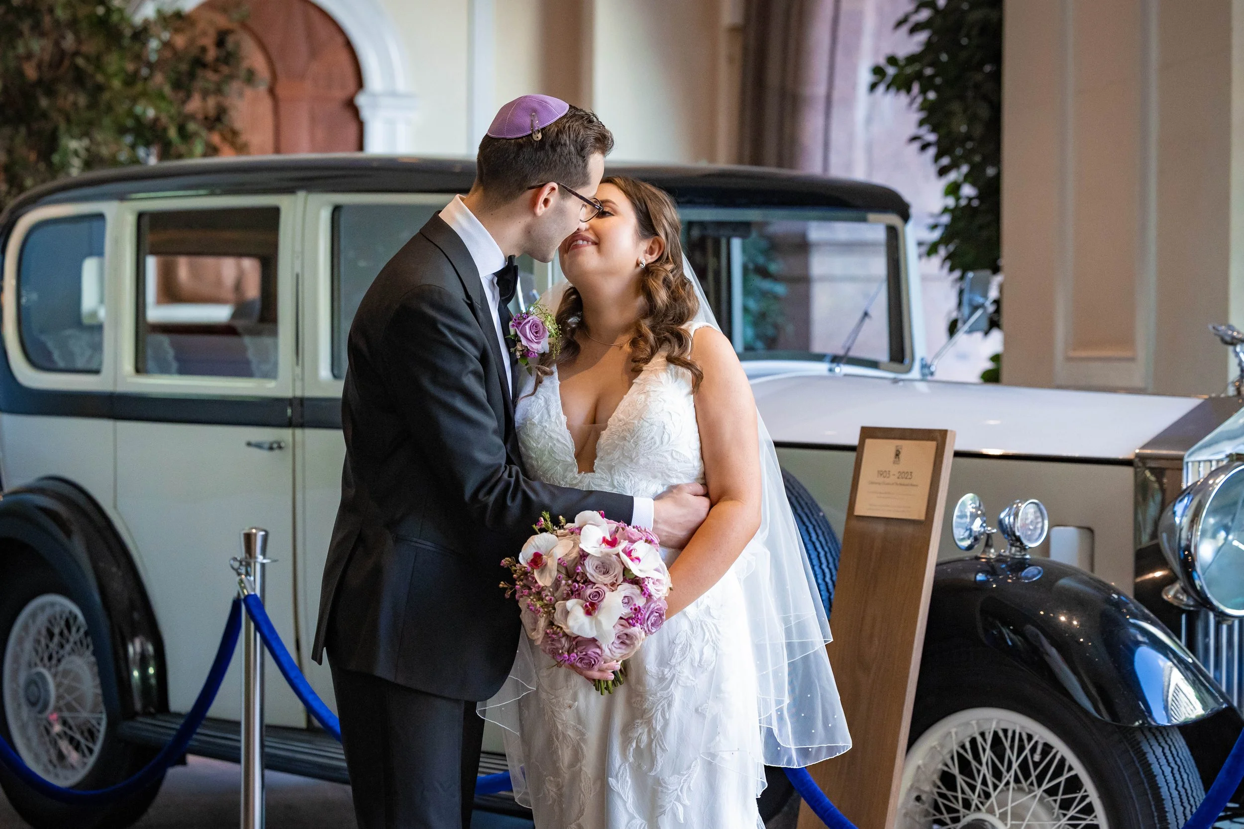 bride and groom newlywed couple portrait with Rolls Royce car at Midland hotel in manchester