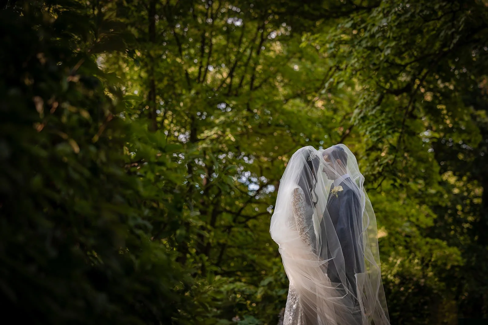 newlywed bride and groom portrait outdoors at worsley marriott hotel wedding venue with veil