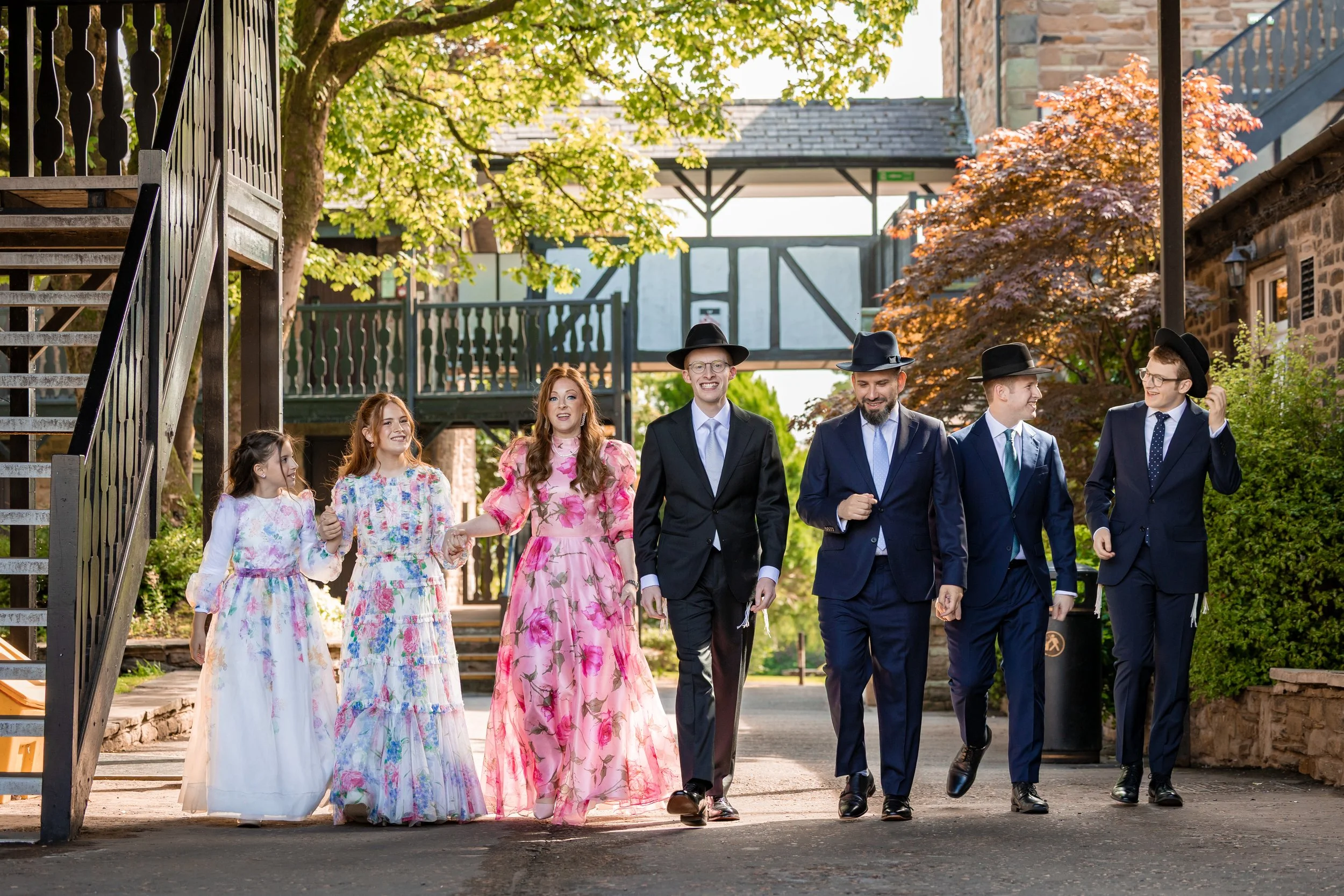 family portraits in courtyard at last drop village wedding venue in bolton