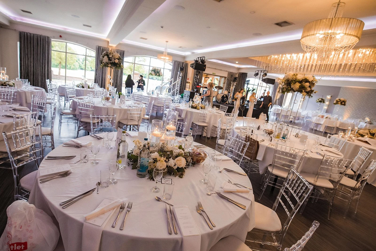 Merrydale Manor wedding reception hall with stage and banquet tables – wedding photographer North West England