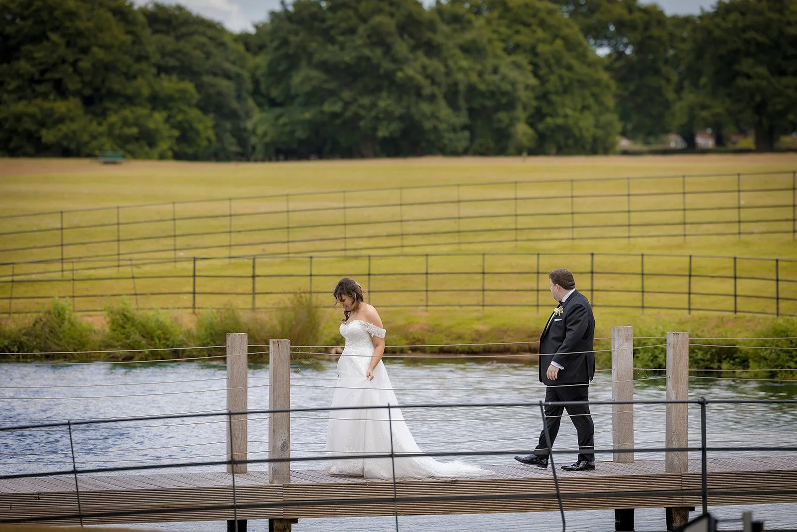 Merrydale Manor wedding bride and groom on wooden dock over water – Manchester wedding photographer