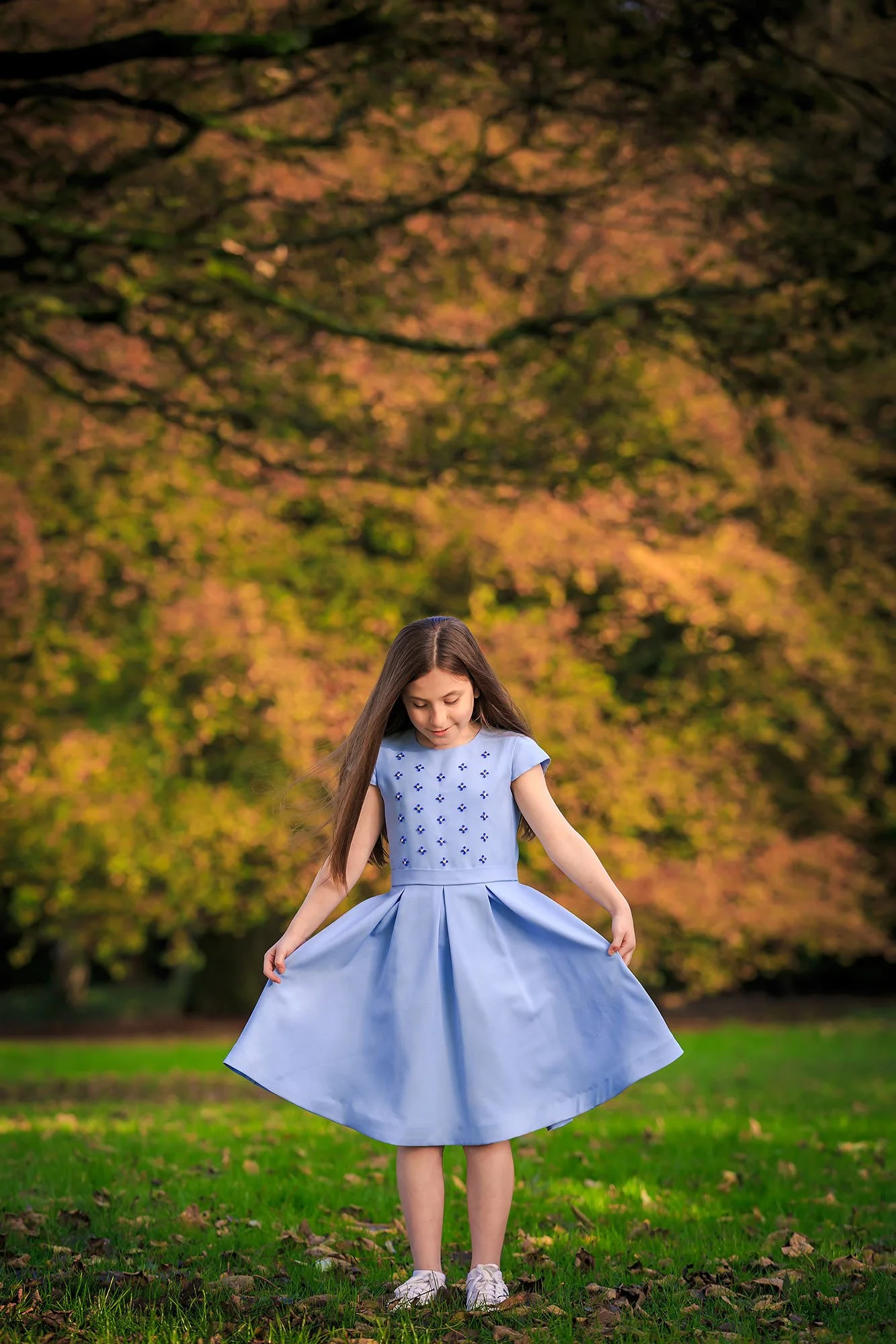 portrait of girl showing off dress in heaton park manchester