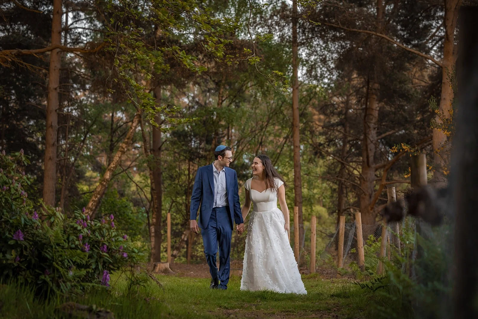 romantic newlywed bride and groom couple portraits in woodland at nunsmere hall in cheshire