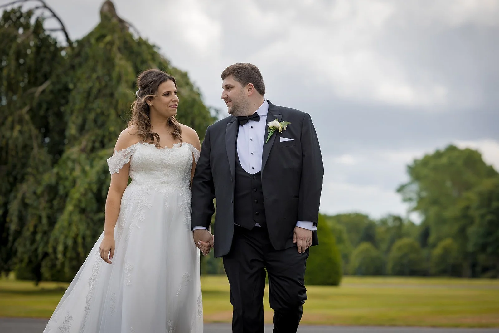 Merrydale Manor wedding couple holding hands outdoors on grounds – documentary wedding photographer Manchester