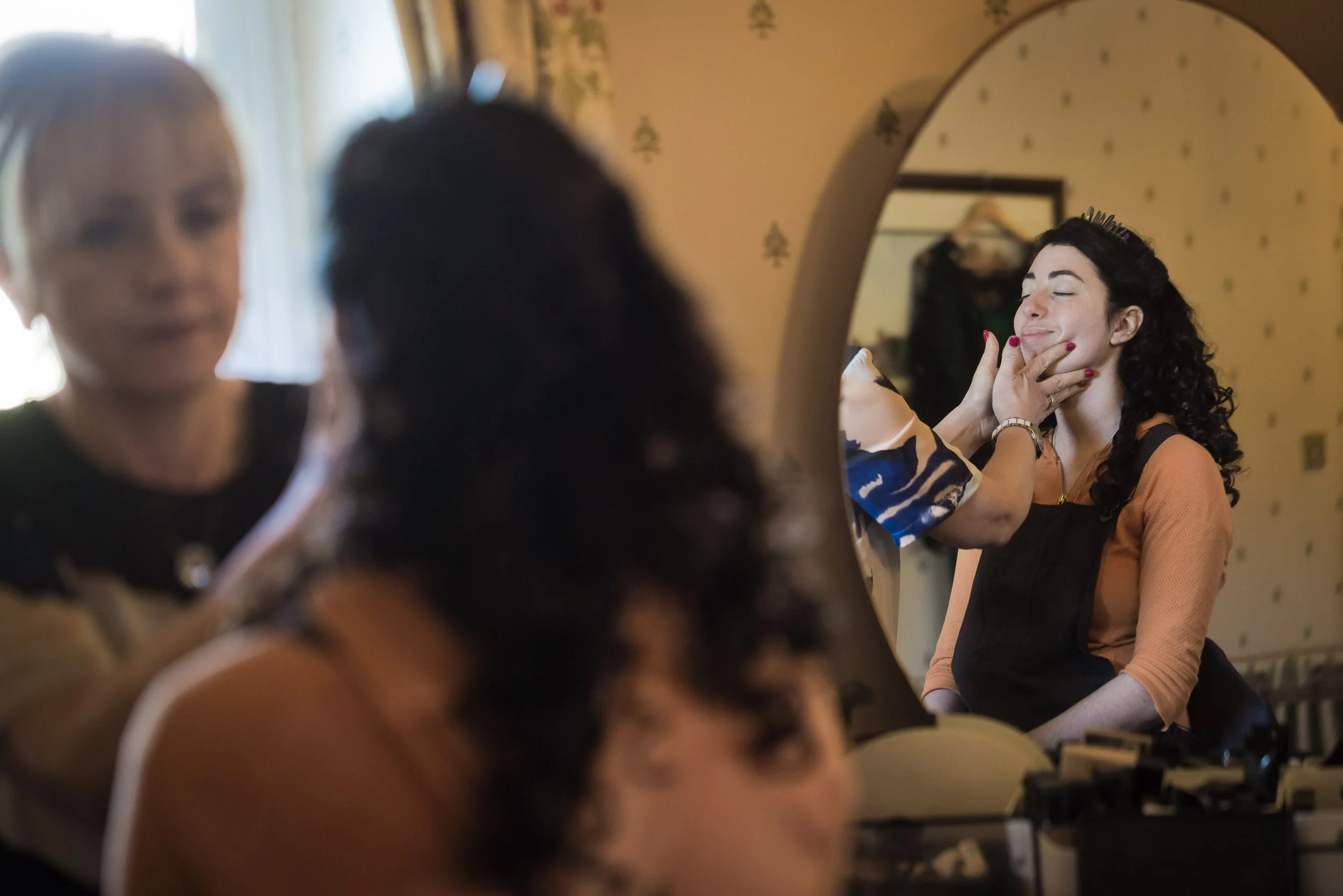 bride having make up done during bridal prep at last drop village in bolton